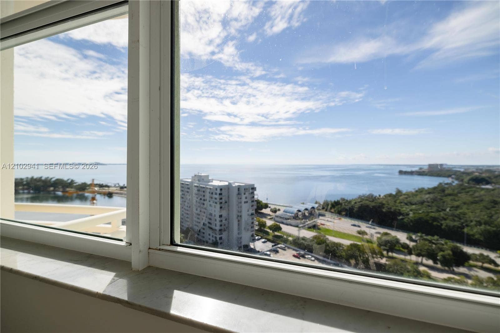 2475 Brickell Avenue, #1807, Miami, FL 33129 Expansive window featuring a polished stone sill and water horizon backdrop