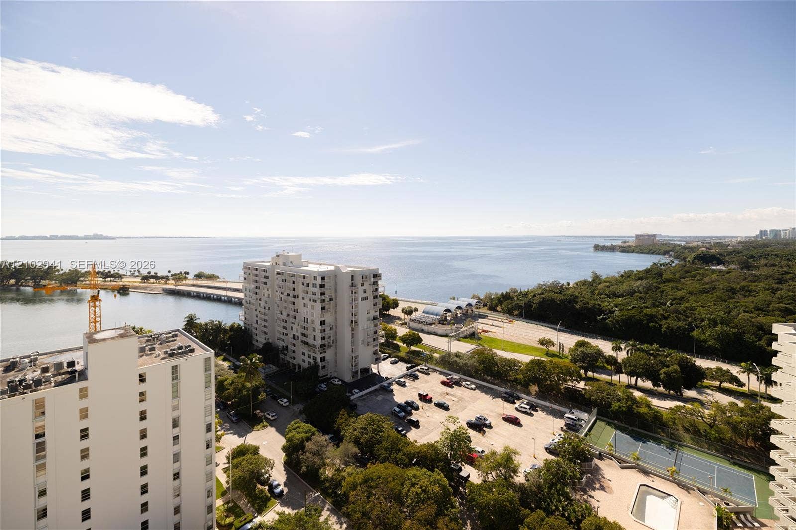 2475 Brickell Avenue, #1807, Miami, FL 33129 Elevated water frontage featuring expansive coastal scenery, mature tree canopy, integrated hardcourt, and paved surface lot