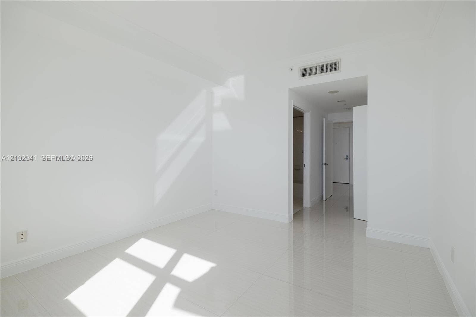 2475 Brickell Avenue, #1807, Miami, FL 33129 Neutral-toned interior space featuring polished tile flooring, recessed ceiling lighting, and smooth-finish walls