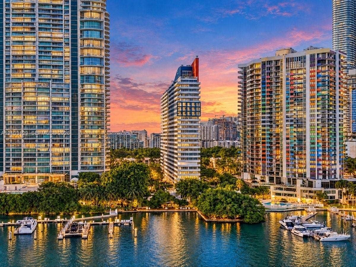 1627 Brickell Avenue, #2005, Miami, FL 33129 High-rise urban architecture featuring floor-to-ceiling glass facades, private balcony tiers, extensive waterfront bulkhead, and deep-water boat slips