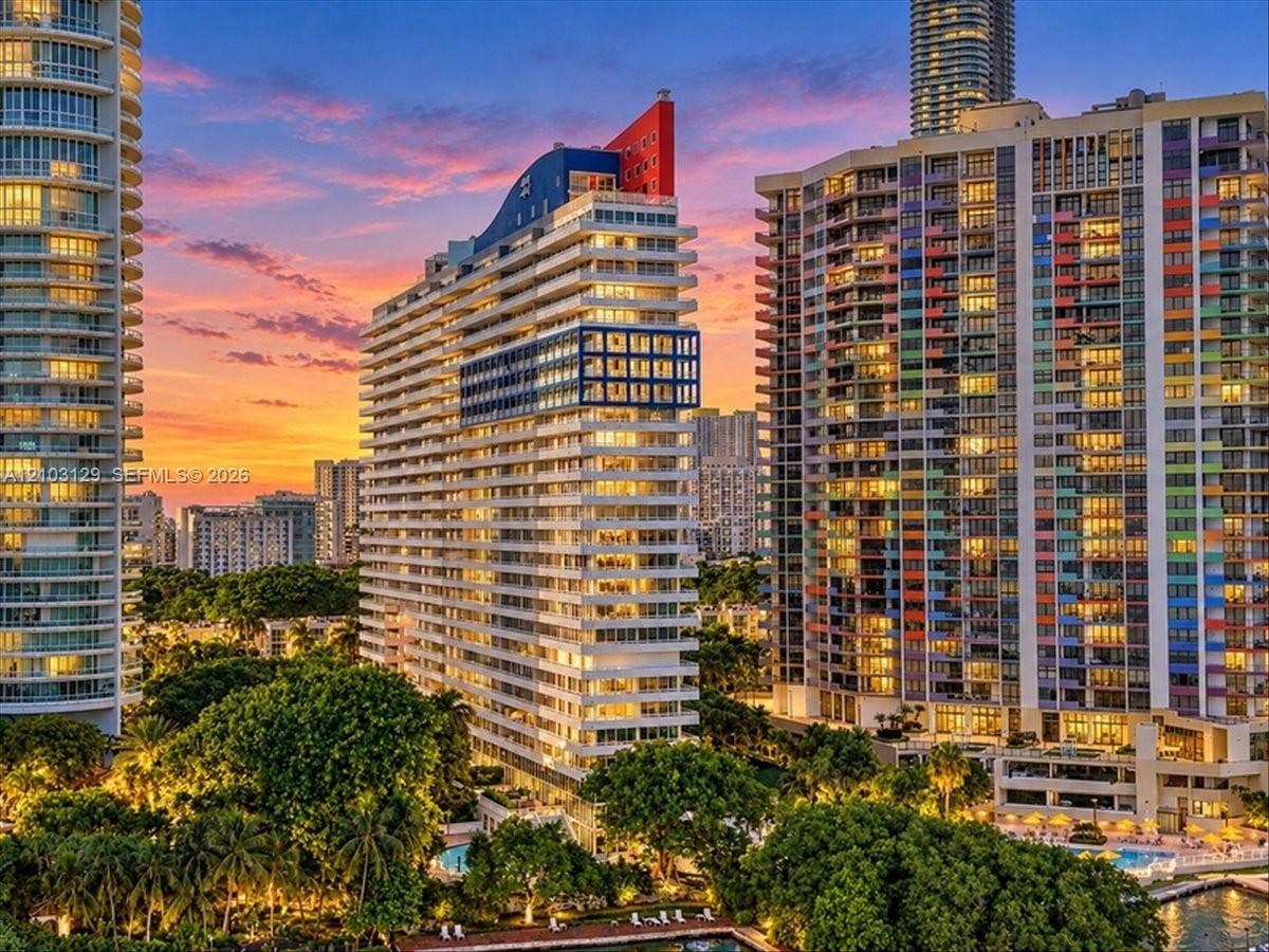 1627 Brickell Avenue, #2005, Miami, FL 33129 High-rise residential tower featuring architectural geometric detailing, balcony facades, and a vibrant sunset backdrop
