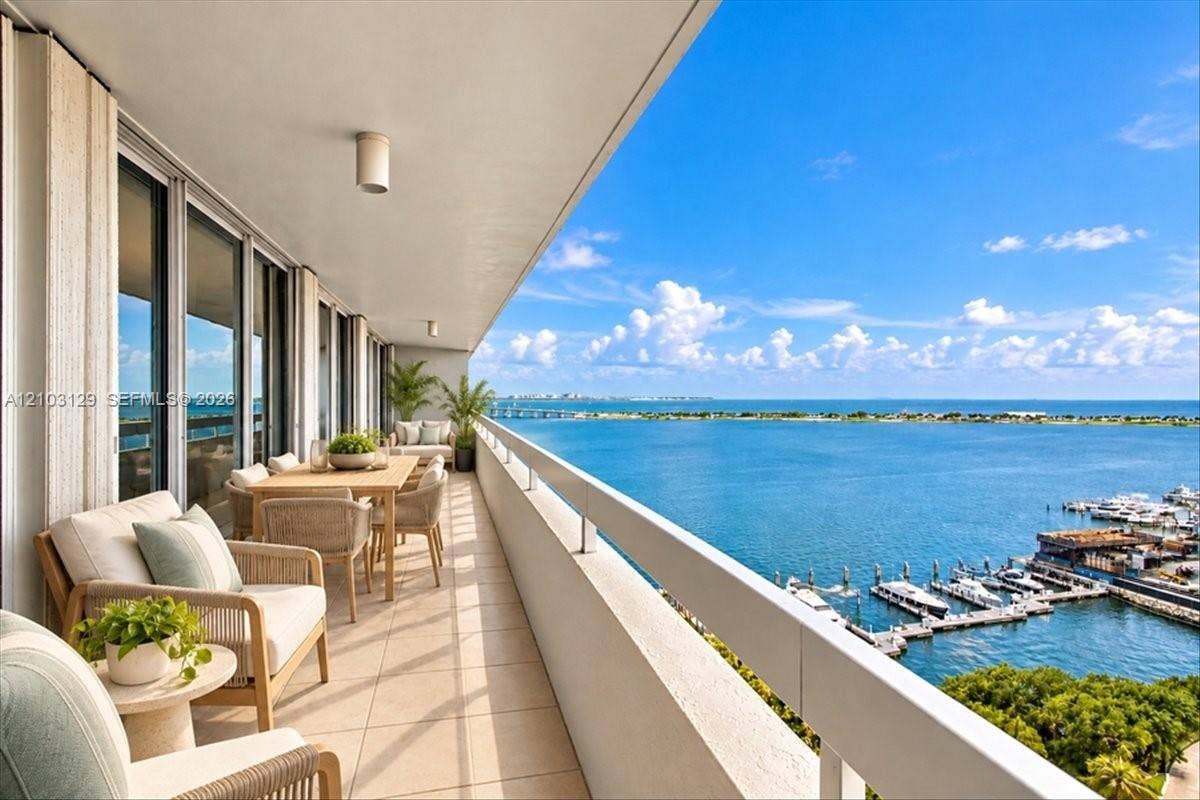 1627 Brickell Avenue, #2005, Miami, FL 33129 Covered balcony featuring expansive tile flooring, a high-gloss ceiling finish, and a full-length metal railing overlooking the water