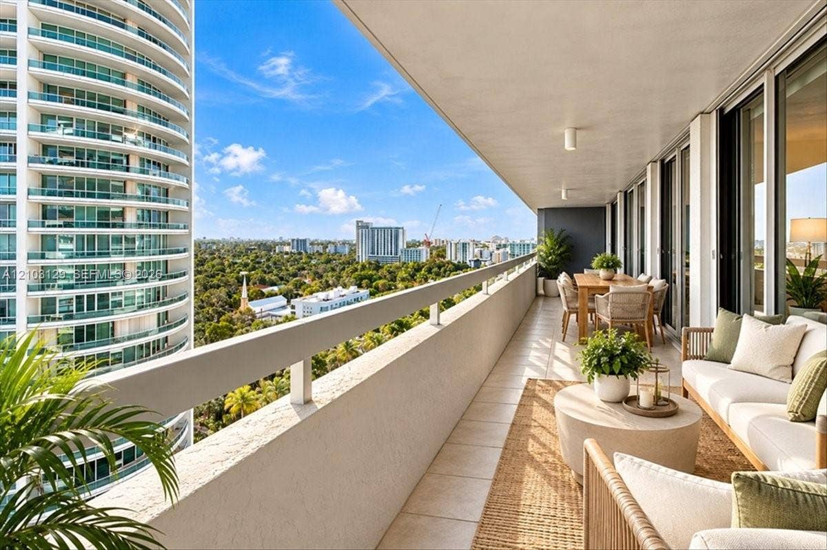 1627 Brickell Avenue, #2005, Miami, FL 33129 Expansive covered balcony featuring tile flooring, a solid wall railing with a metal top rail, and recessed ceiling lighting