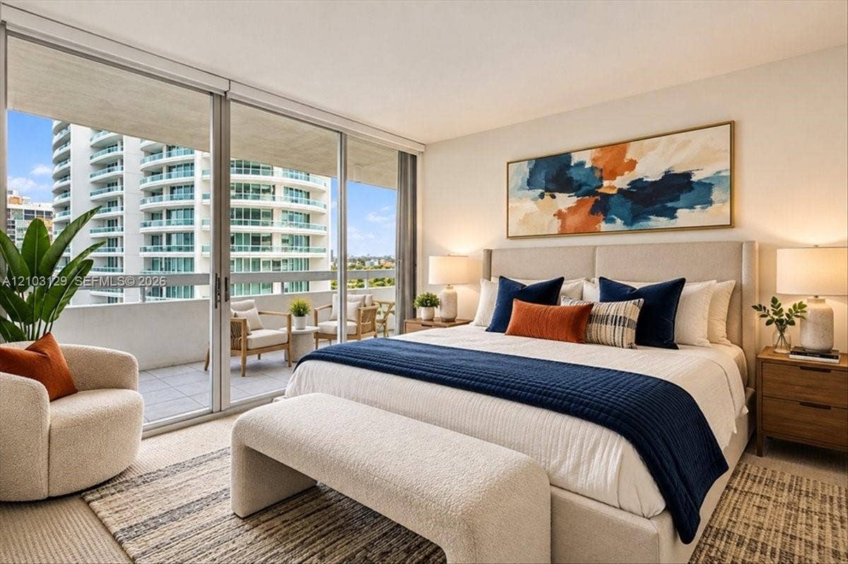 1627 Brickell Avenue, #2005, Miami, FL 33129 Floor-to-ceiling sliding glass doors opening to a private balcony, wall-to-wall carpeting, and neutral interior finishes