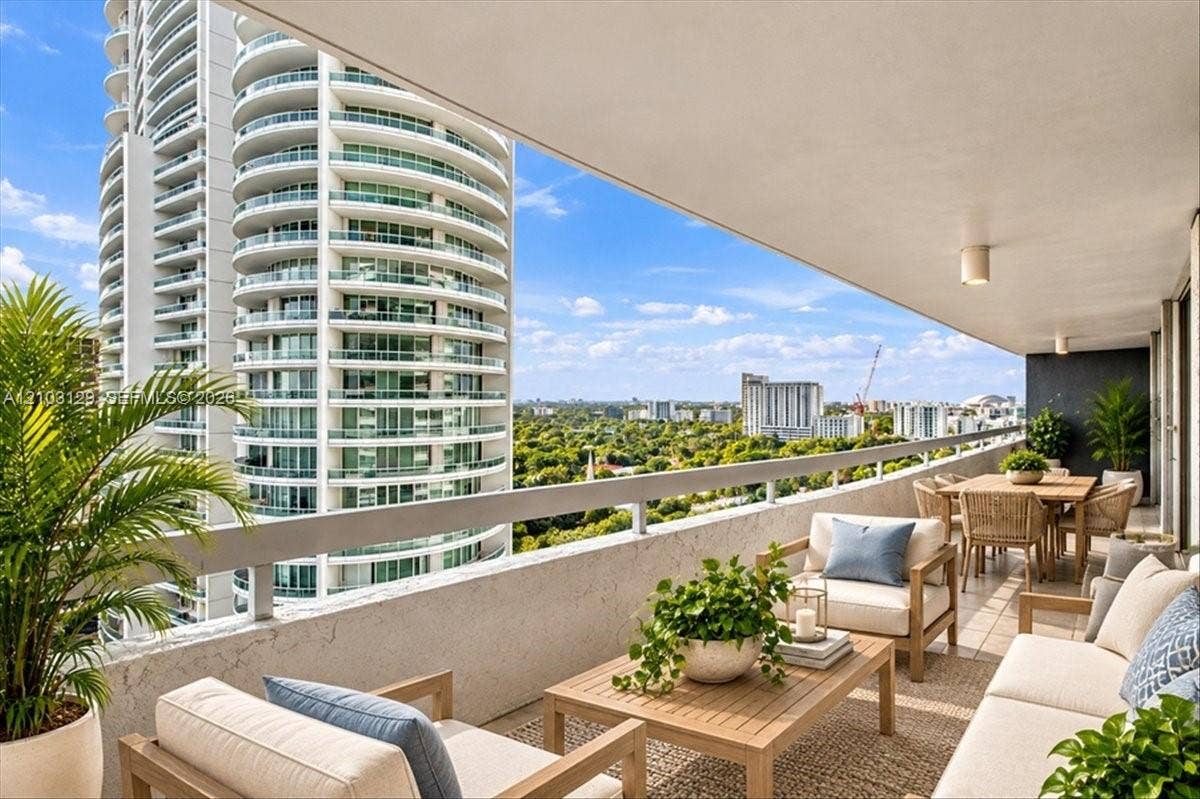1627 Brickell Avenue, #2005, Miami, FL 33129 Expansive covered balcony featuring a concrete perimeter railing, recessed ceiling lighting, and large-format tile flooring