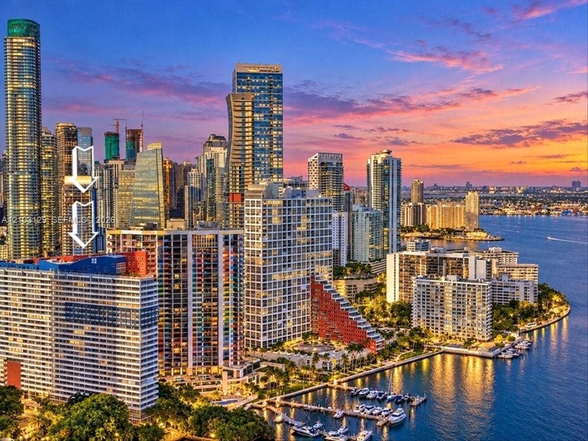 1627 Brickell Avenue, #2005, Miami, FL 33129 High-rise residential building featuring an urban skyline backdrop, water frontage, and balcony space