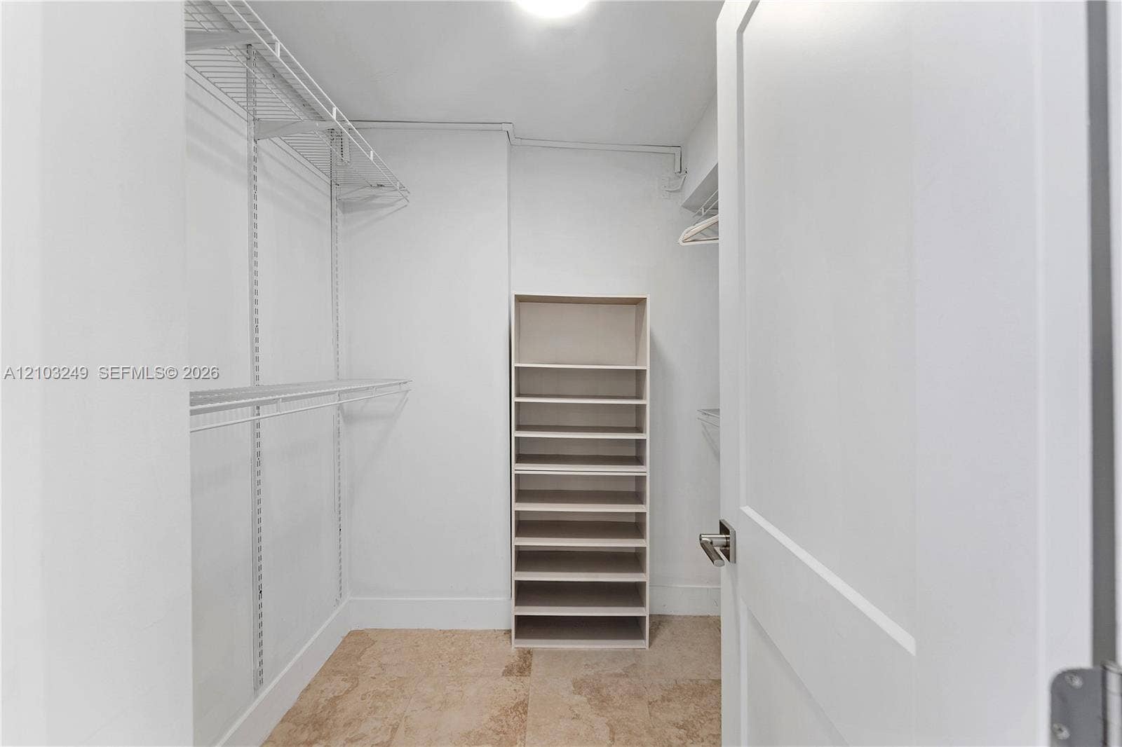 Walkin closet with built-ins; primary bedroom off bath and dressing area