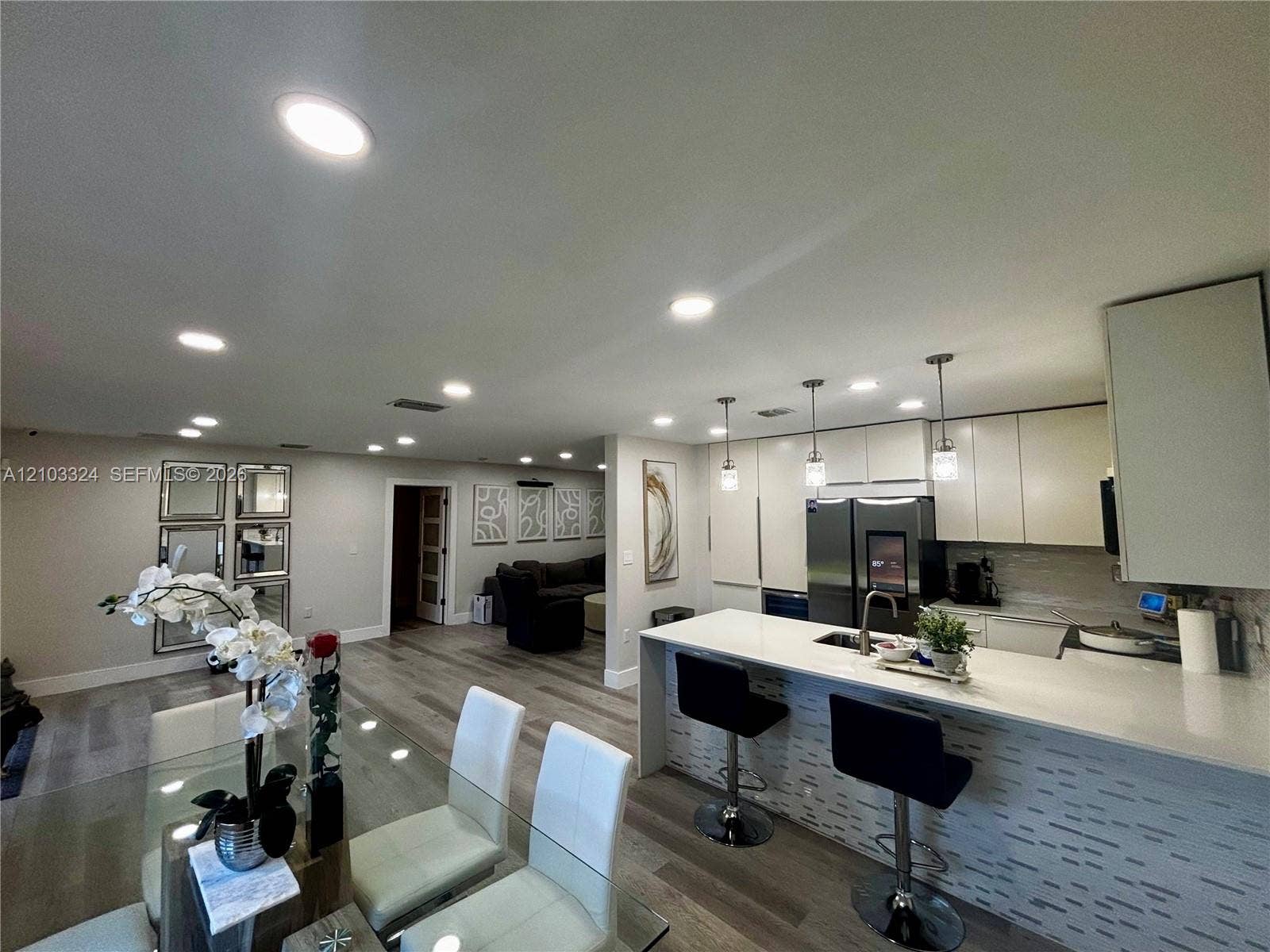 13413 SW 256th Street, Homestead, FL 33032 Kitchen featuring flat-panel cabinetry, quartz countertops, a waterfall island, recessed lighting, and pendant fixtures over the breakfast bar