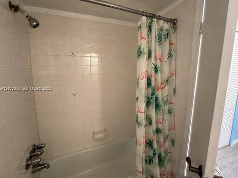 26 Diplomat Parkway, #2342, Hallandale Beach, FL 33009 Tub and shower combination with white square wall tile, integrated soap dish, and chrome-finish fixtures