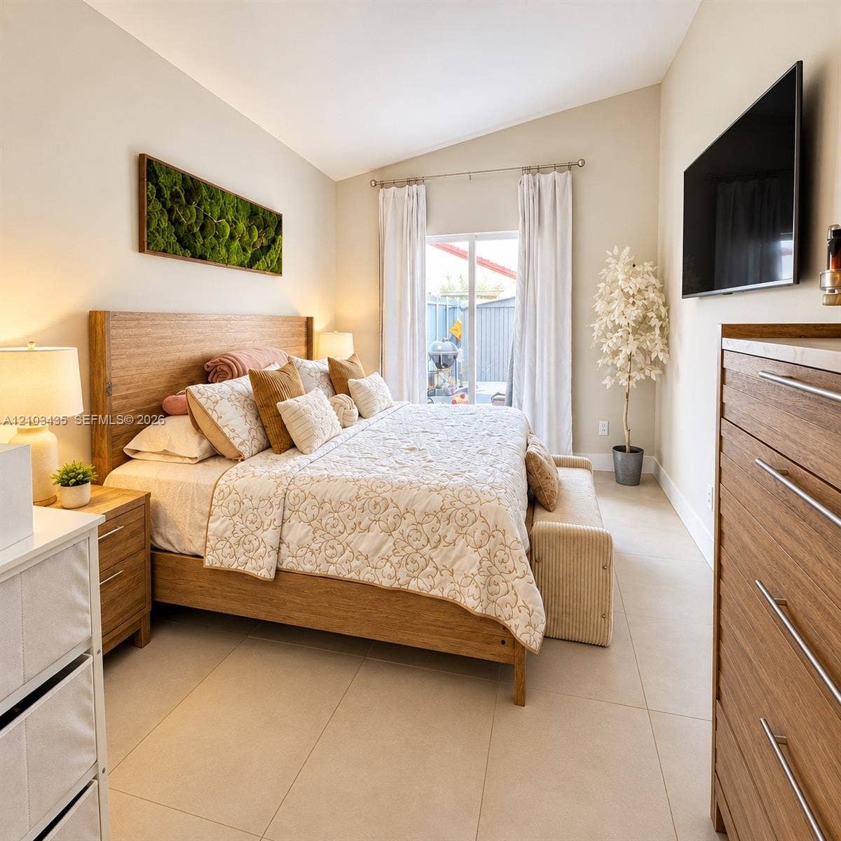 Miami, FL 33177 Vaulted ceiling featuring neutral wall paint, large-format tile flooring, and a sliding glass door