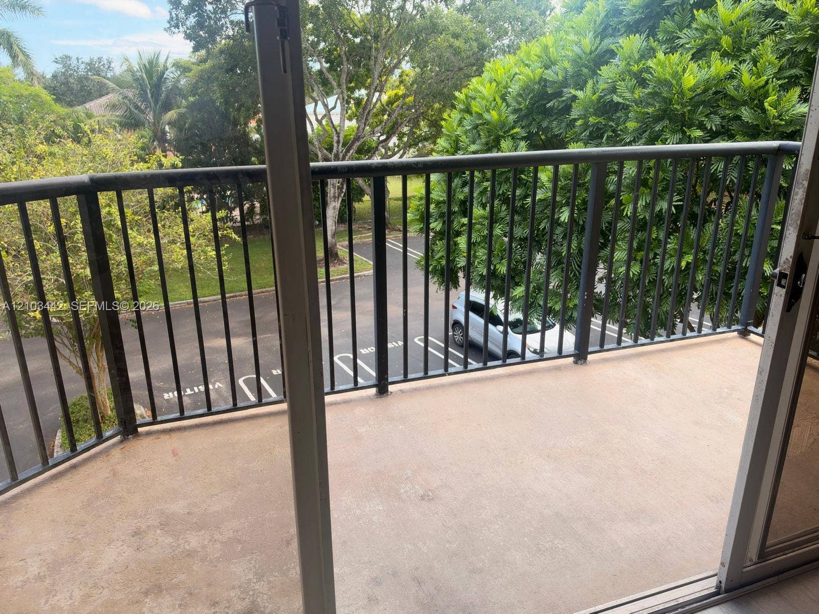 8721 Wiles Road, #303, Coral Springs, FL 33067 Balcony featuring a concrete surface and black metal railing