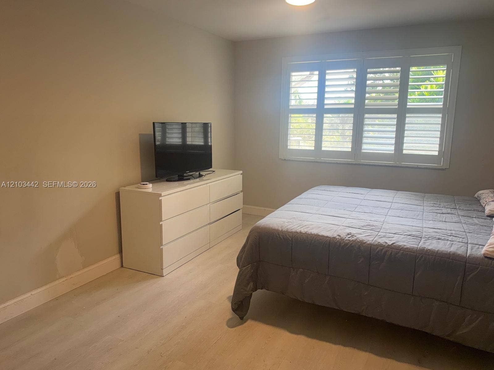 8721 Wiles Road, #303, Coral Springs, FL 33067 Neutral-toned walls paired with light-finish flooring and window shutter treatments