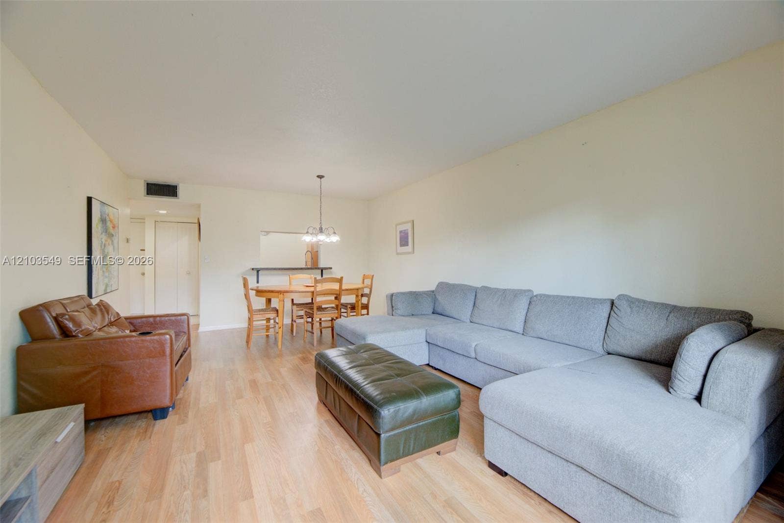 8901 N New River Canal Road, #4W, Plantation, Plantation, FL 33324 Open-concept living space featuring wood-finish flooring and a central pendant light fixture