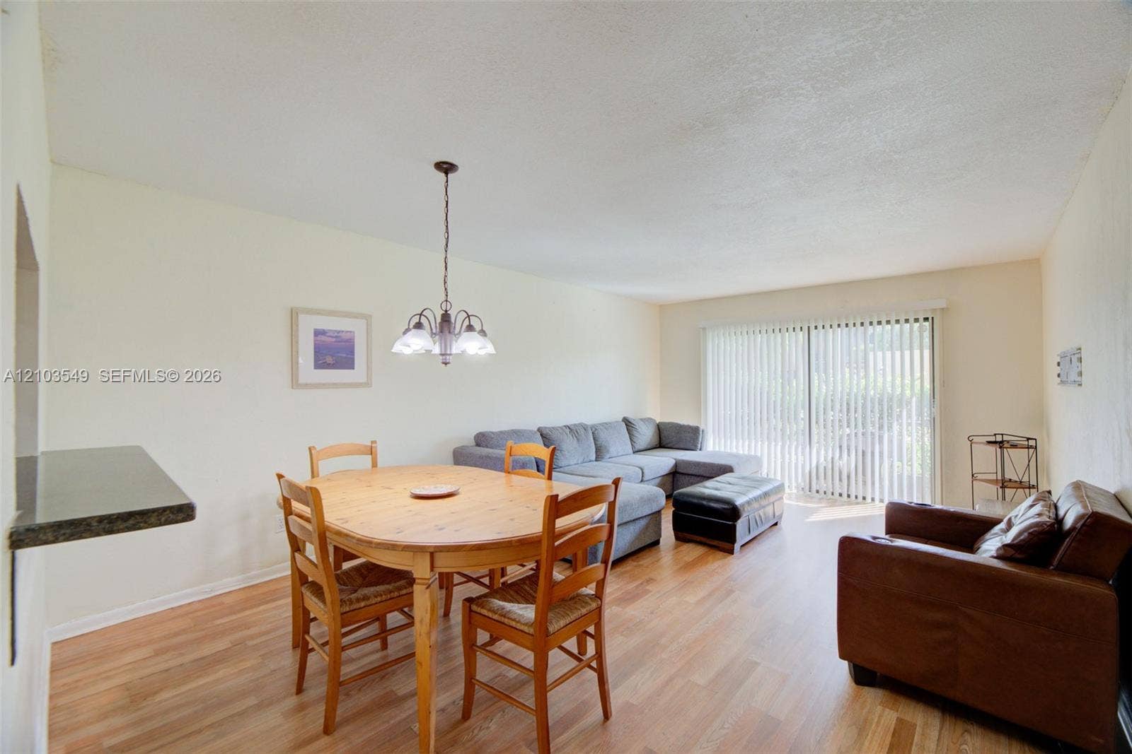 8901 N New River Canal Road, #4W, Plantation, Plantation, FL 33324 Wood-finish flooring, sliding glass doors, built-in breakfast bar, and multi-arm chandelier lighting