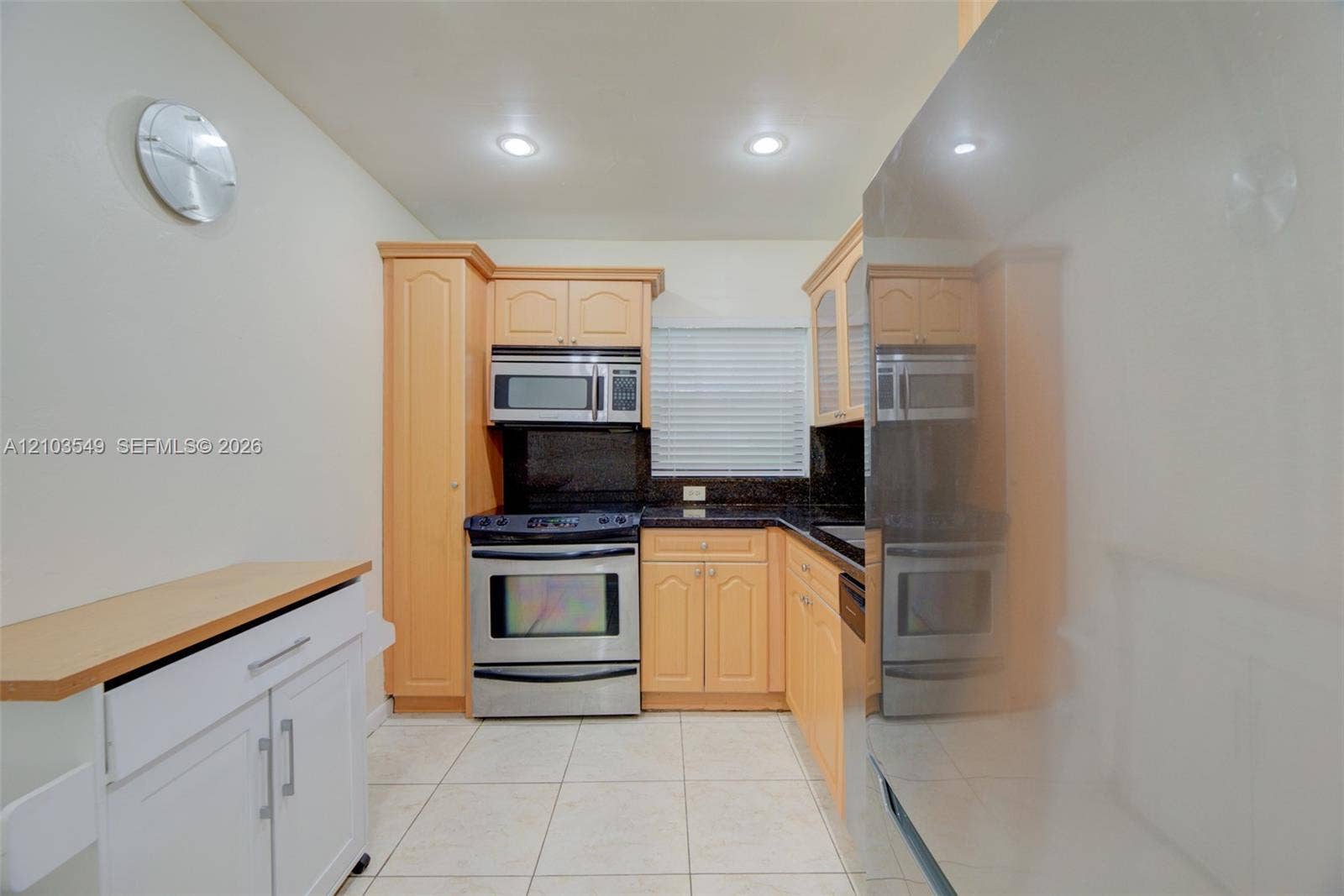 8901 N New River Canal Road, #4W, Plantation, Plantation, FL 33324 Kitchen featuring light wood cabinetry, dark stone countertops, stainless steel appliances, tile flooring, and recessed ceiling lighting