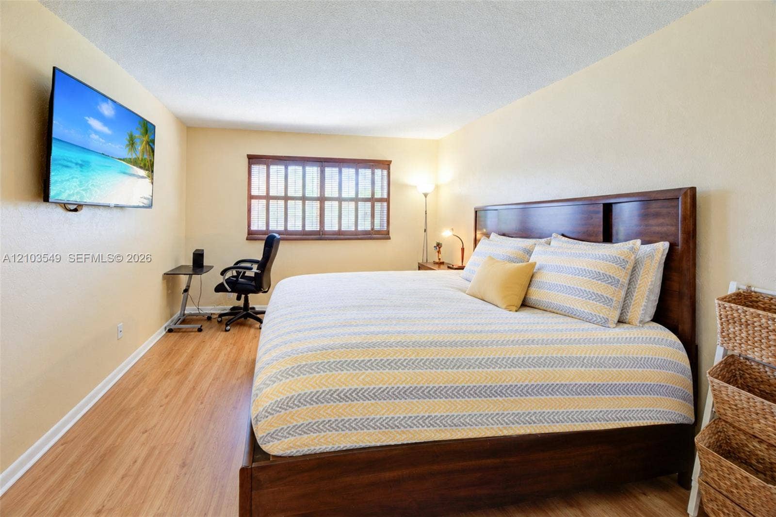 8901 N New River Canal Road, #4W, Plantation, Plantation, FL 33324 Wood-finish flooring, multi-pane window with dark-toned frame, and wall-mounted television hardware