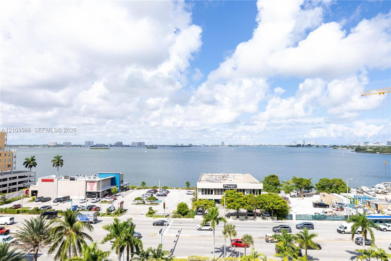 7901 Hispanola Avenue, #801, North Bay Village, FL 33141 Elevated perspective featuring expansive water frontage and mature palm trees