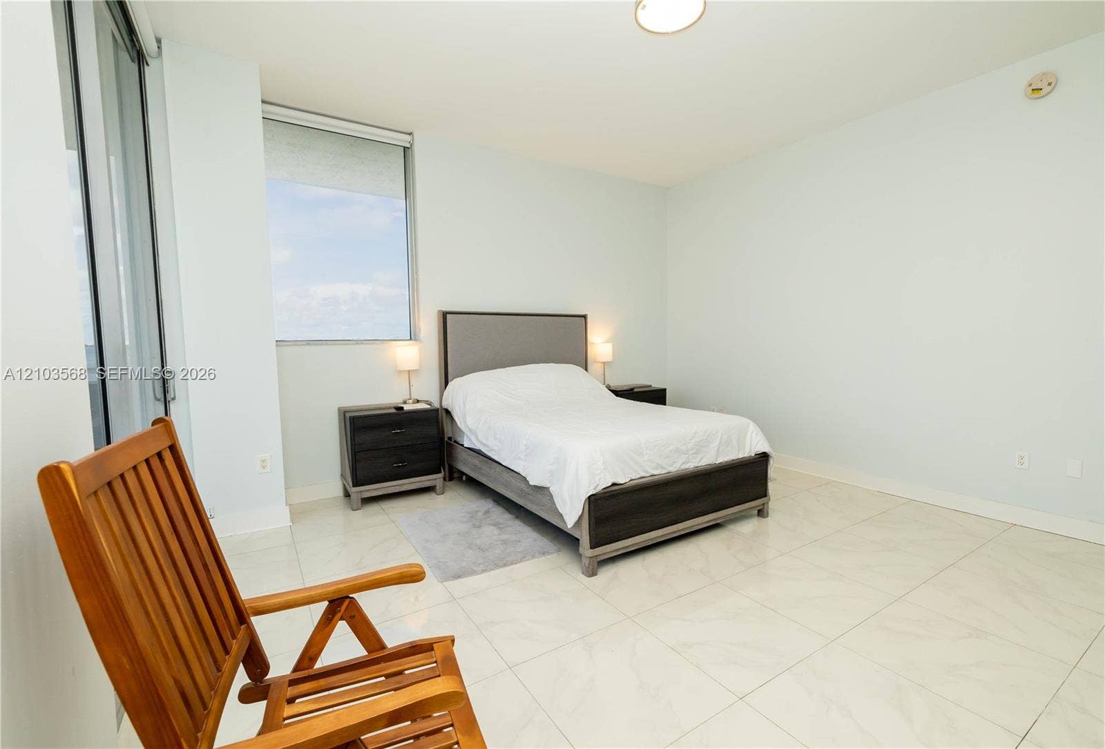 7901 Hispanola Avenue, #801, North Bay Village, FL 33141 Large-format tile flooring, expansive window, and ceiling-mounted lighting fixture