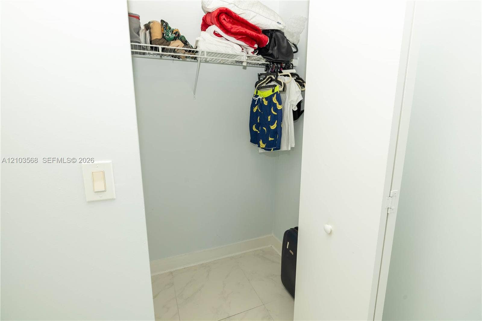 7901 Hispanola Avenue, #801, North Bay Village, FL 33141 Storage closet featuring wire shelving and stone-finish floor tiling