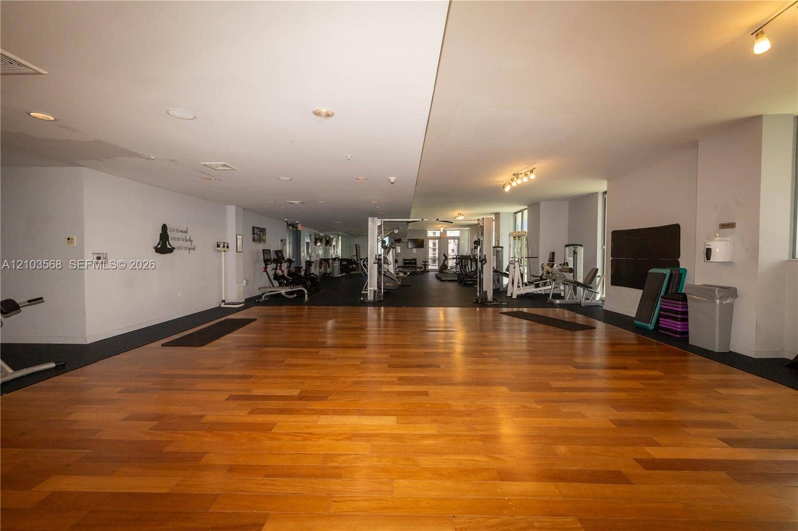 7901 Hispanola Avenue, #801, North Bay Village, FL 33141 Spacious fitness area featuring wood-finish flooring, recessed ceiling lighting, and track lighting fixtures