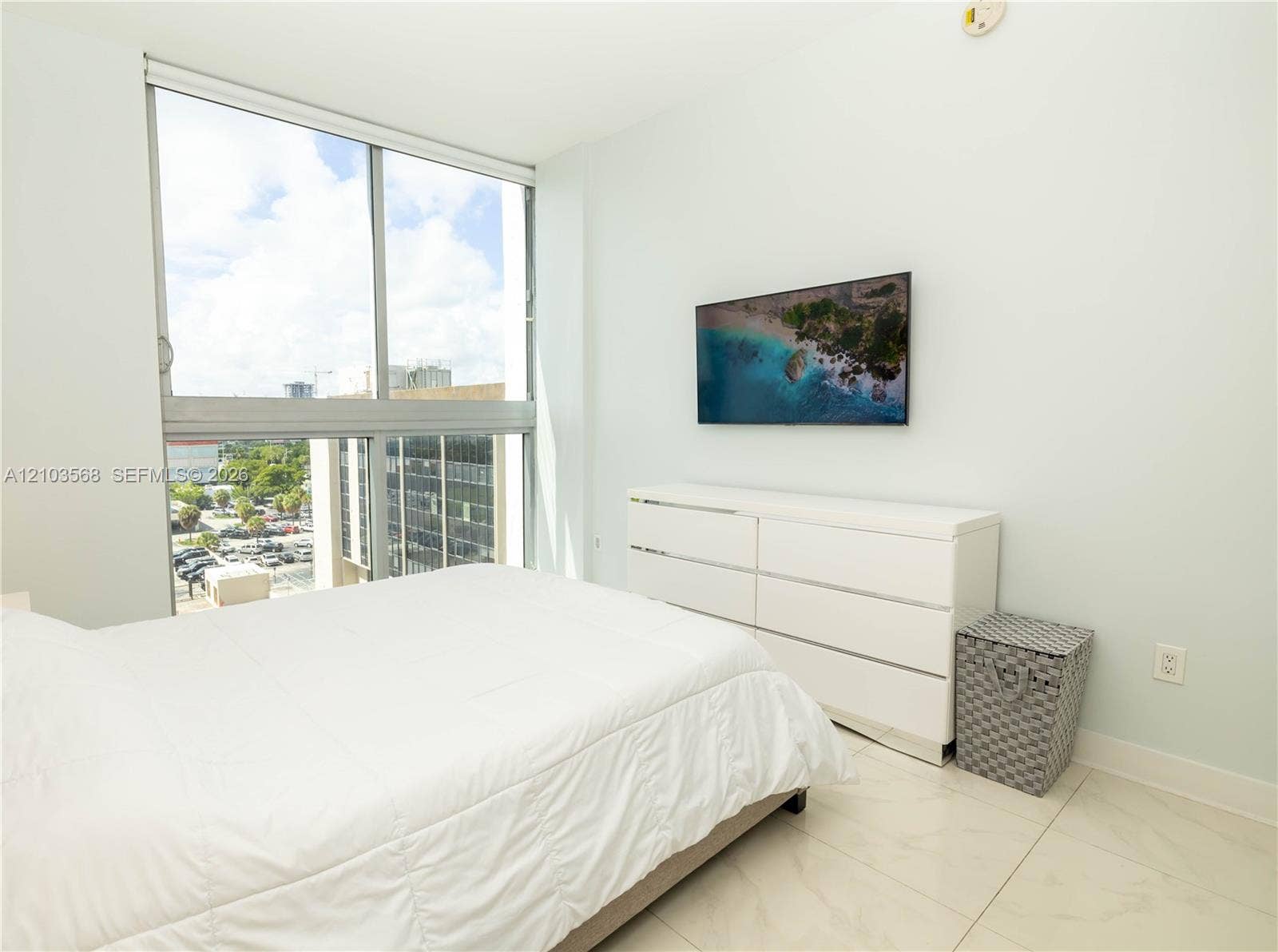 7901 Hispanola Avenue, #801, North Bay Village, FL 33141 Floor-to-ceiling windows featuring urban scenery and large-format porcelain tile flooring
