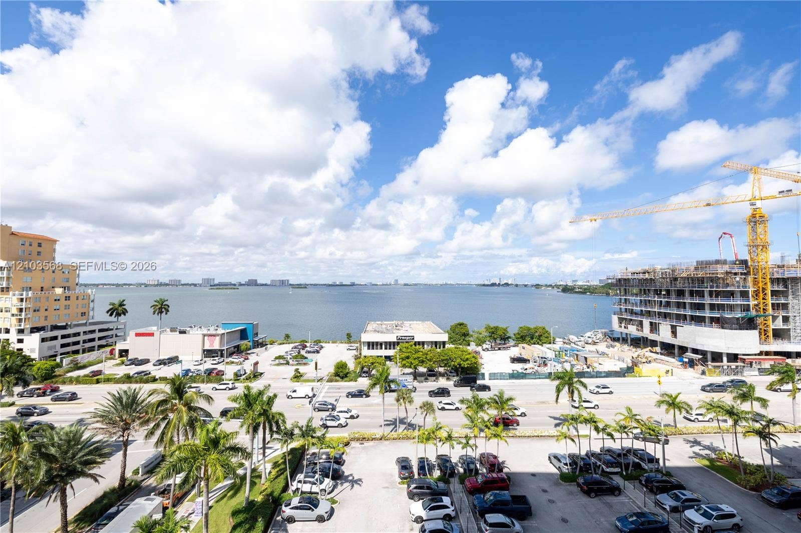 7901 Hispanola Avenue, #801, North Bay Village, FL 33141 Expansive coastal water frontage featuring tropical palm trees and urban skyline presence