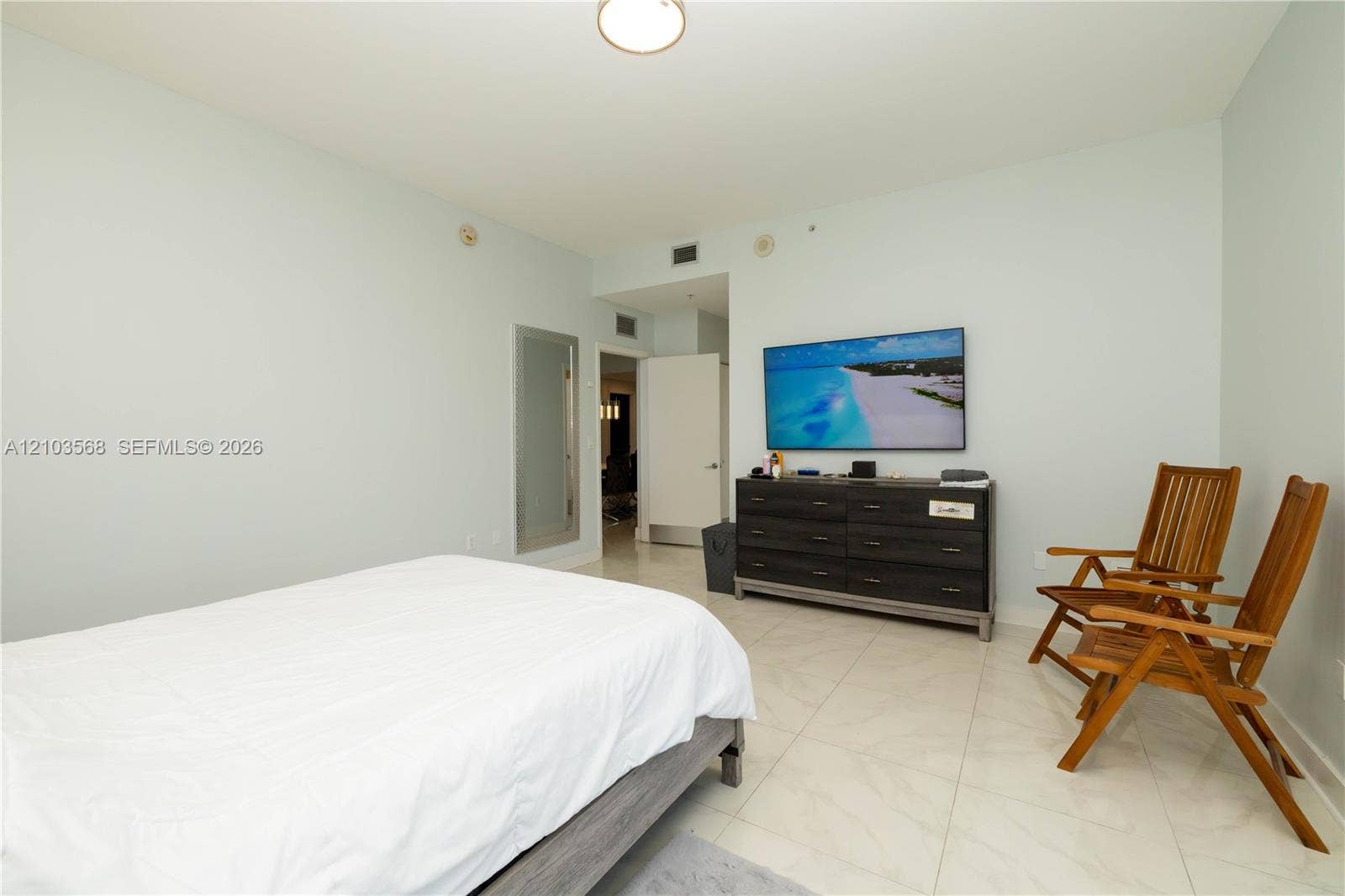 7901 Hispanola Avenue, #801, North Bay Village, FL 33141 Interior space featuring large-format tile flooring, a flush-mount ceiling light fixture, and a neutral wall finish