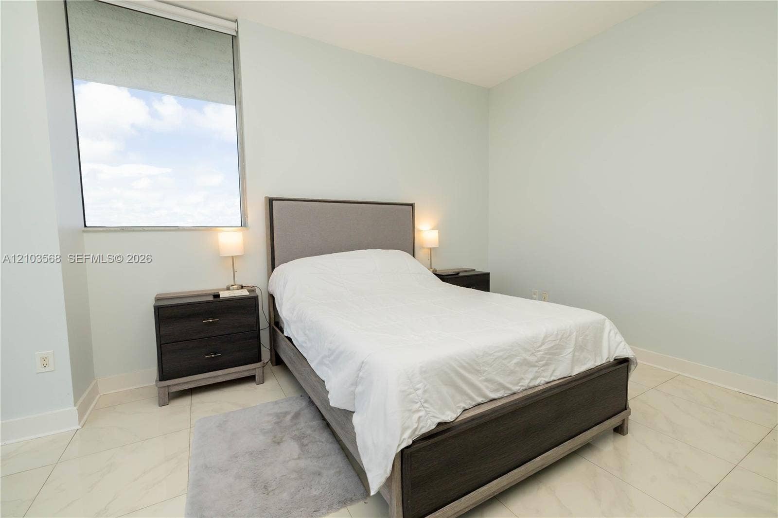 7901 Hispanola Avenue, #801, North Bay Village, FL 33141 Light-filled room featuring polished tile flooring and a large floor-to-ceiling window