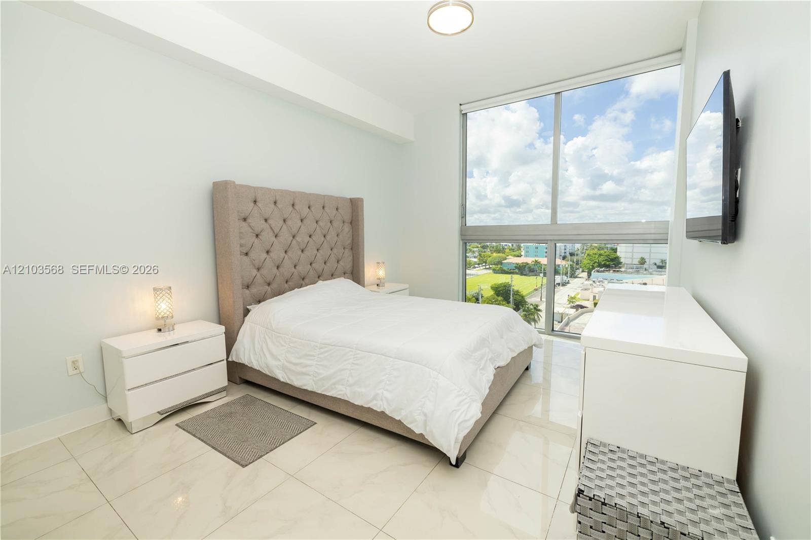 7901 Hispanola Avenue, #801, North Bay Village, FL 33141 Floor-to-ceiling windows, polished light-toned tile flooring, and flush-mount ceiling lighting