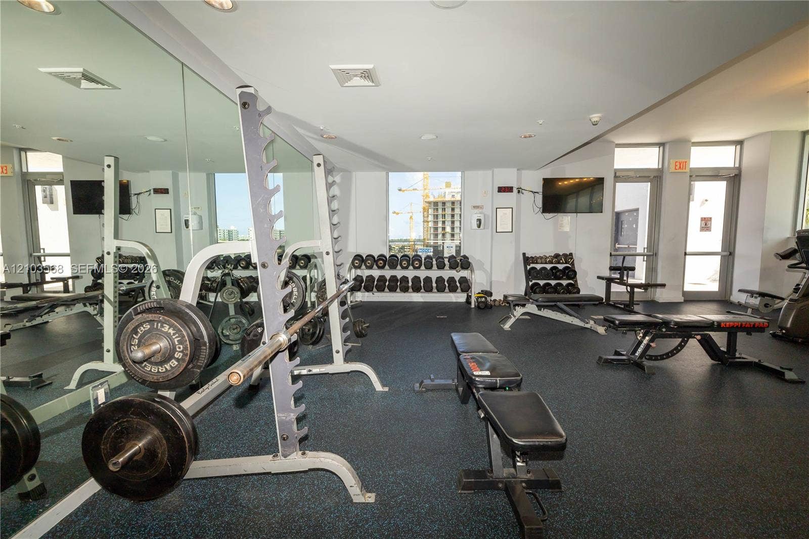 7901 Hispanola Avenue, #801, North Bay Village, FL 33141 Fitness facility featuring wall-to-wall mirrors, durable rubberized flooring, and recessed ceiling lighting