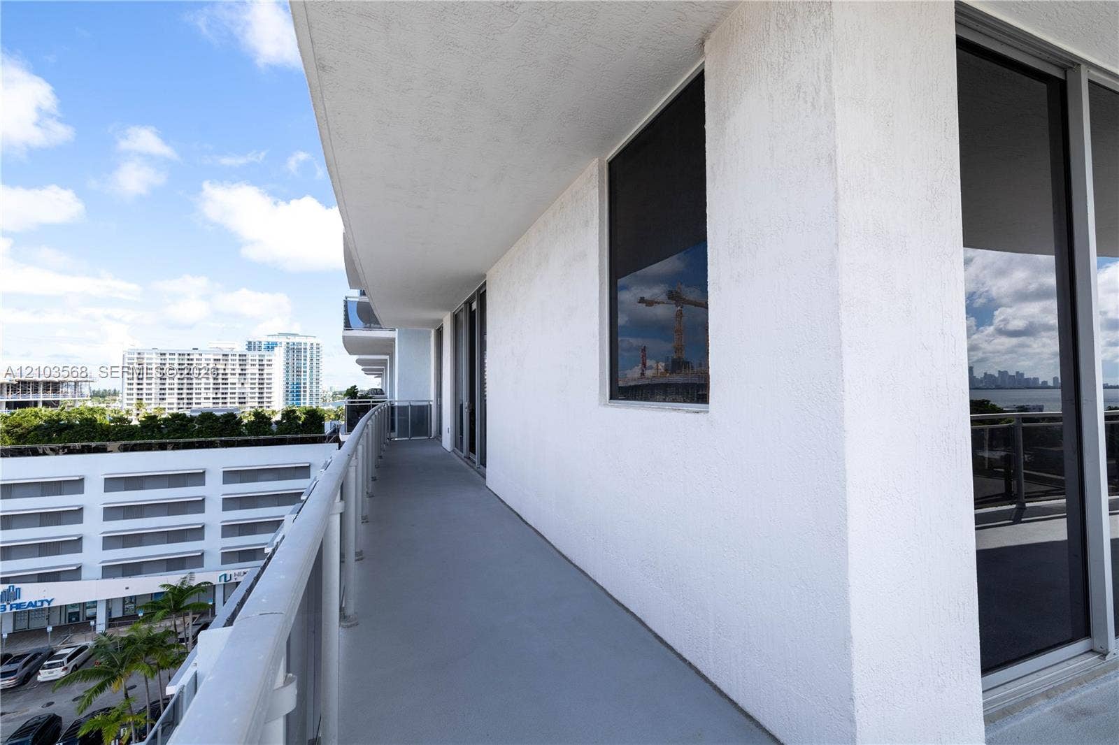 7901 Hispanola Avenue, #801, North Bay Village, FL 33141 Covered private balcony featuring concrete flooring, stucco wall finish, and metal railing with glass inserts