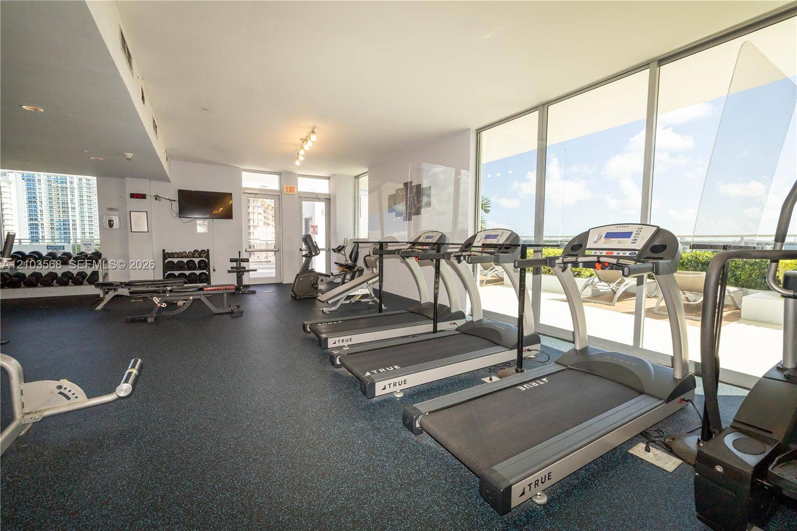 7901 Hispanola Avenue, #801, North Bay Village, FL 33141 Fitness center featuring rubber flooring, floor-to-ceiling windows, and track lighting