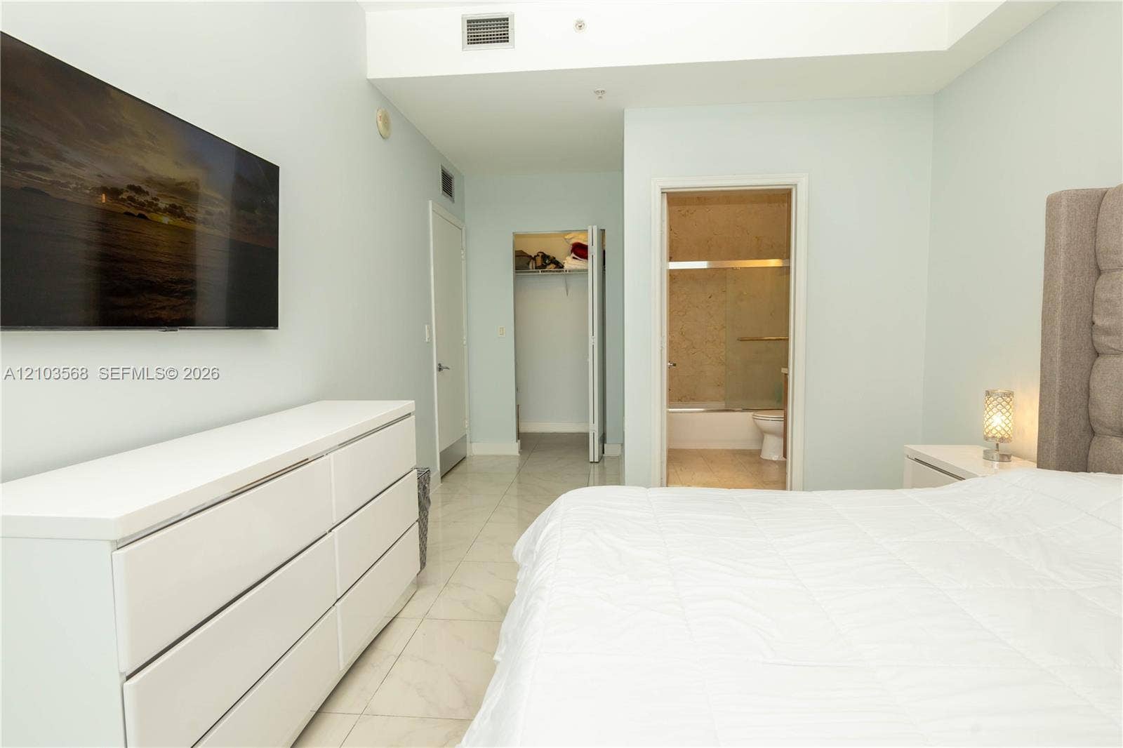 7901 Hispanola Avenue, #801, North Bay Village, FL 33141 Polished stone-finish flooring, walk-in closet with built-in shelving, and neutral wall tones
