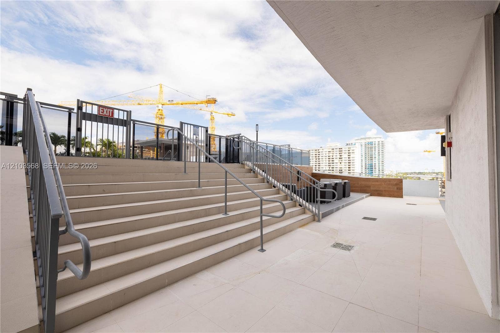7901 Hispanola Avenue, #801, North Bay Village, FL 33141 Outdoor terrace featuring light-toned tile flooring, metal railings, and a wide staircase