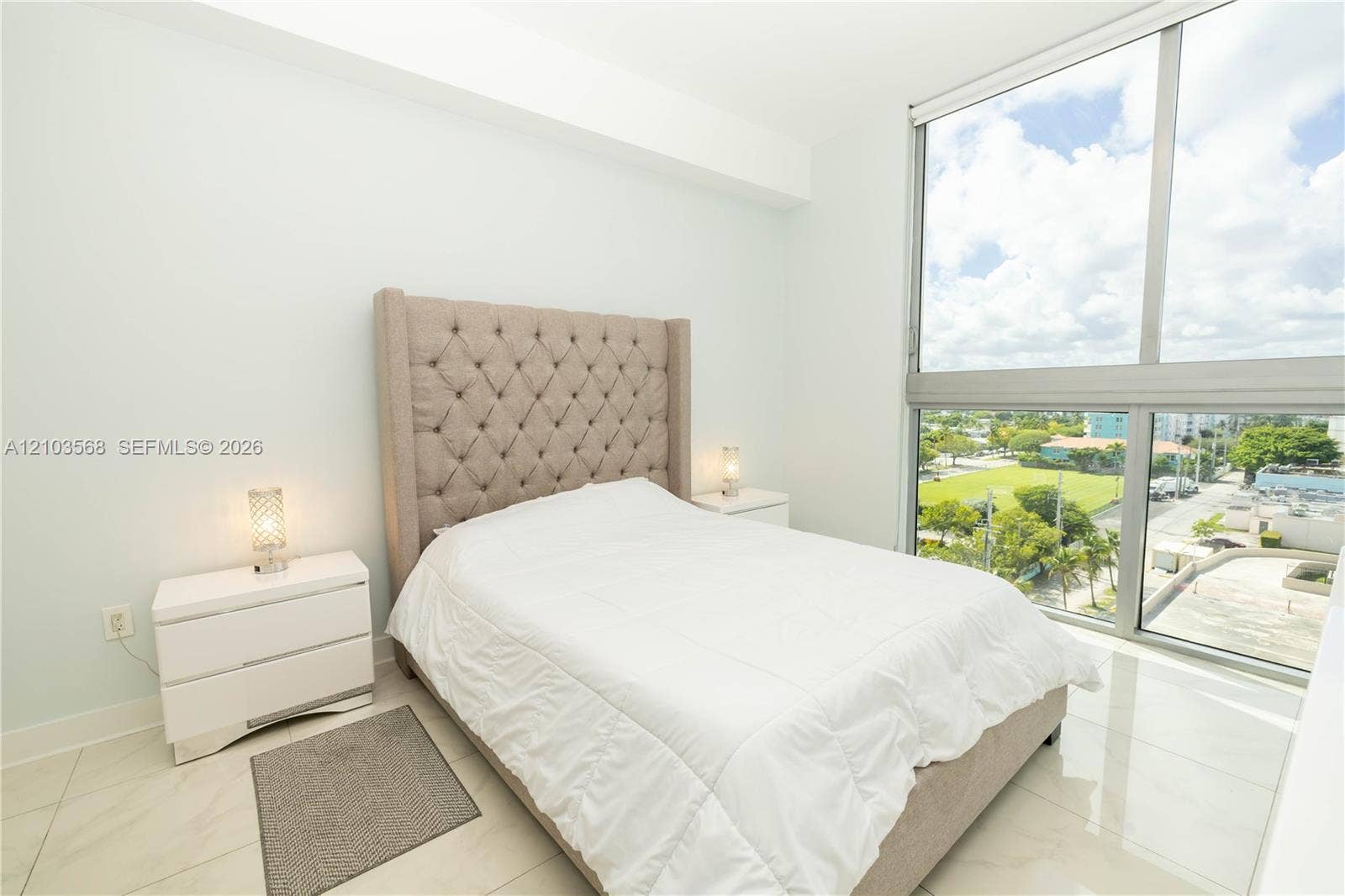 7901 Hispanola Avenue, #801, North Bay Village, FL 33141 Floor-to-ceiling windows featuring external landscape scenery, polished stone-finish flooring, and high-reaching ceiling height