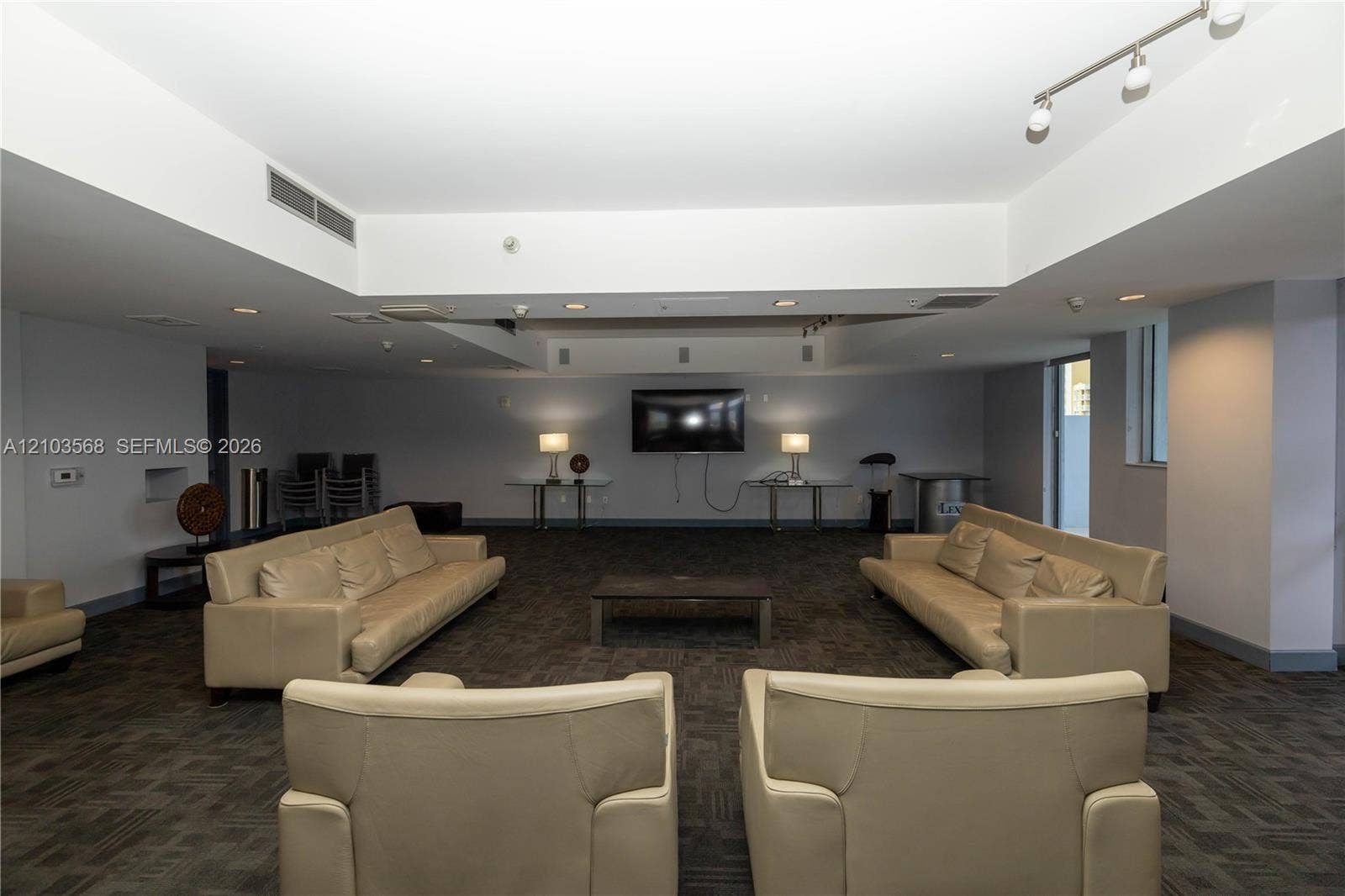 7901 Hispanola Avenue, #801, North Bay Village, FL 33141 Open-concept interior featuring recessed lighting, track lighting fixtures, and neutral carpet flooring