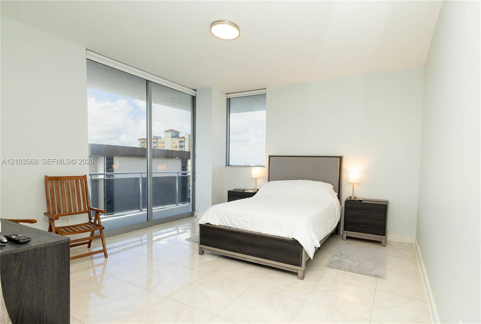 7901 Hispanola Avenue, #801, North Bay Village, FL 33141 Floor-to-ceiling sliding glass doors, polished stone-finish flooring, and recessed ceiling lighting