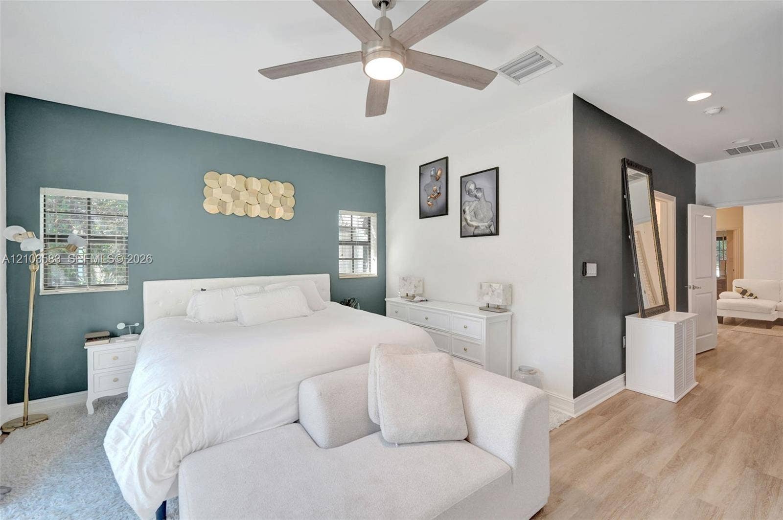 Room featuring dual-tone painted walls, recessed lighting, wood-finish flooring, and a ceiling fan with integrated light fixture