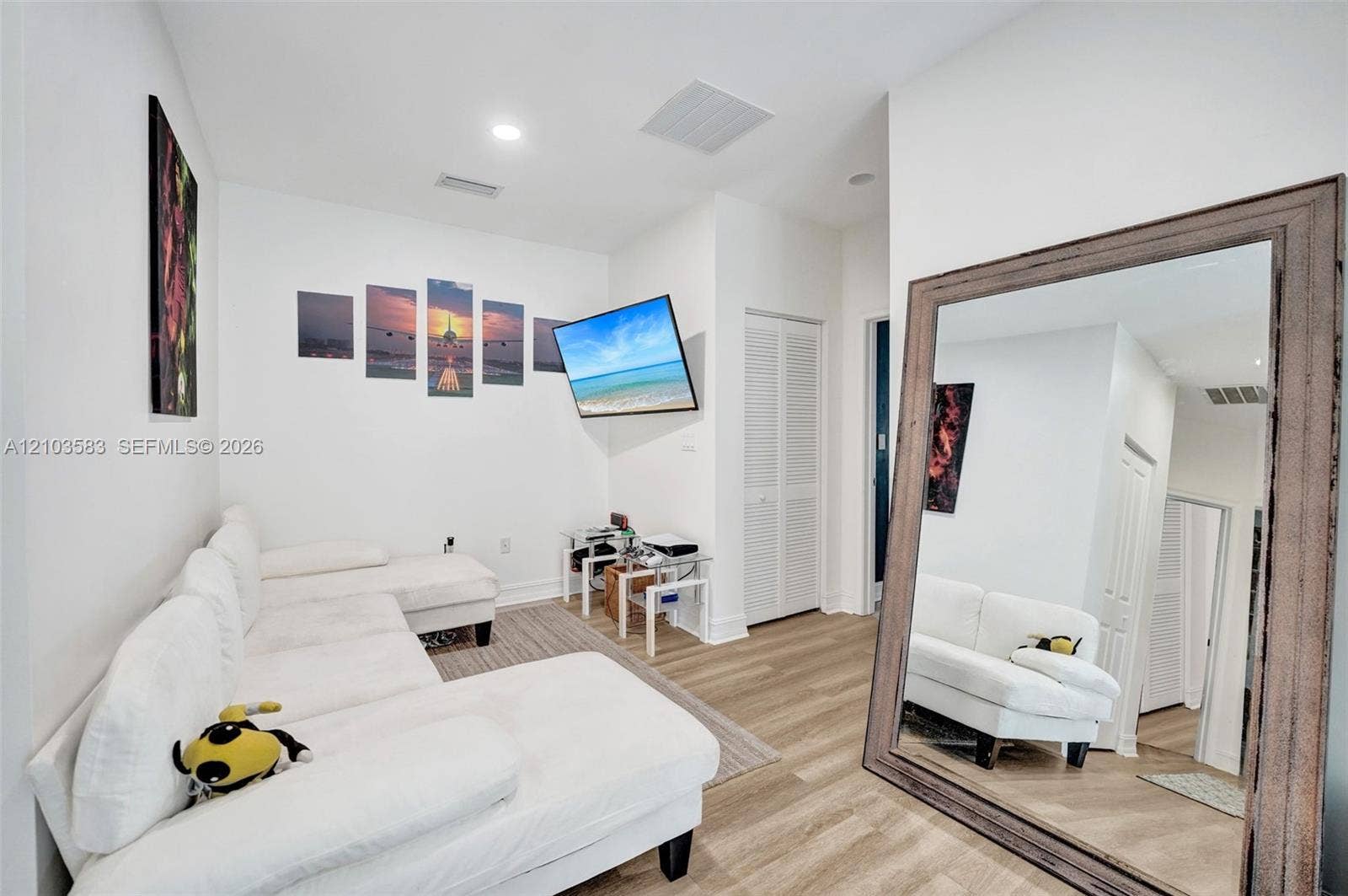 Interior space featuring wood-finish flooring, recessed lighting, and a closet with louvered doors