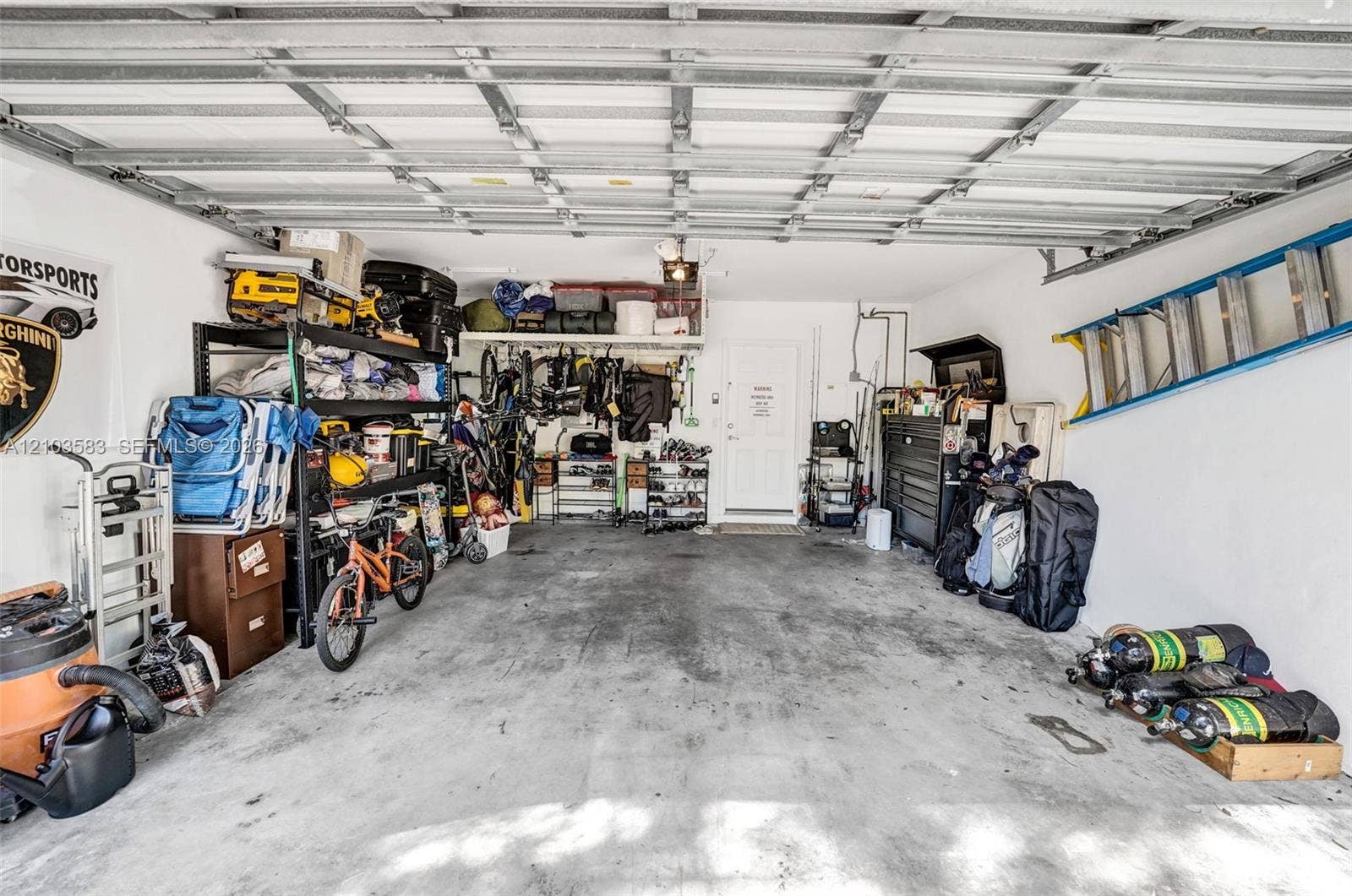 Attached garage featuring a concrete floor, painted interior walls, and an exterior entry door