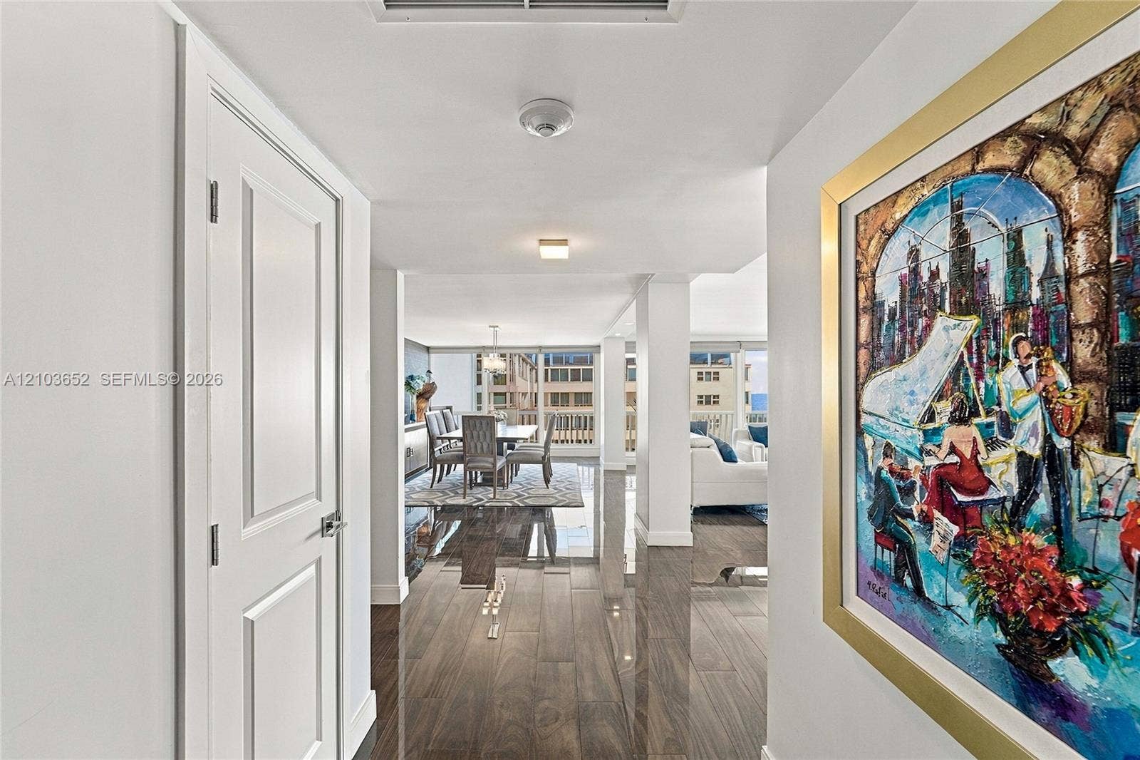 Polished wood-finish flooring, crisp white walls, and flush-mount ceiling lighting