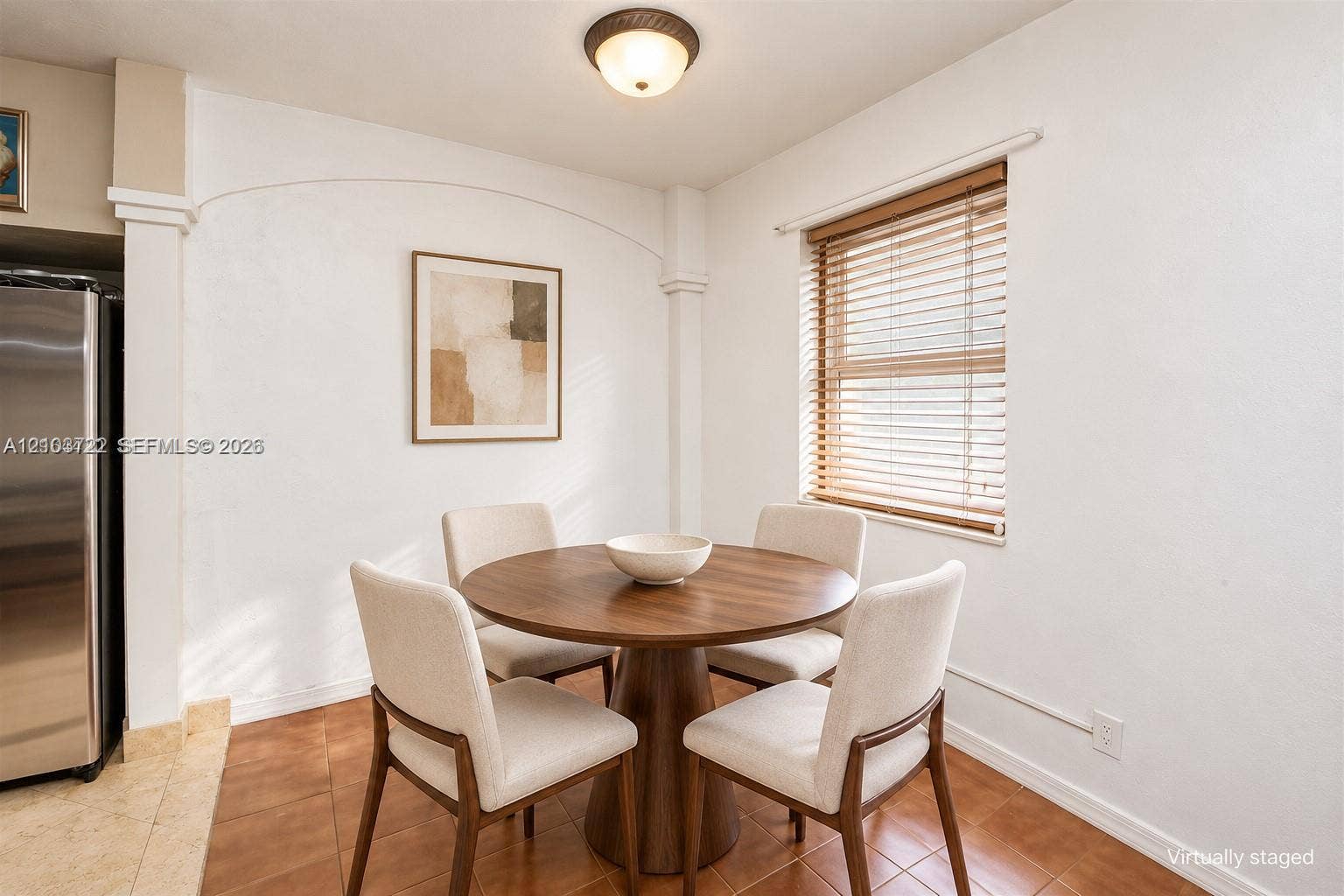 Eat-in area featuring tile flooring, a window with horizontal blinds, and a semi-flush mount ceiling light