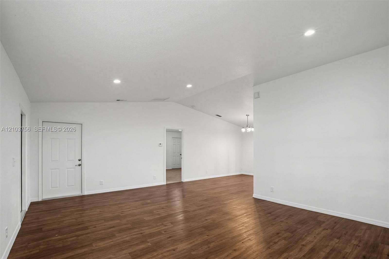 Interior space featuring vaulted ceilings, wood-finish flooring, and recessed lighting