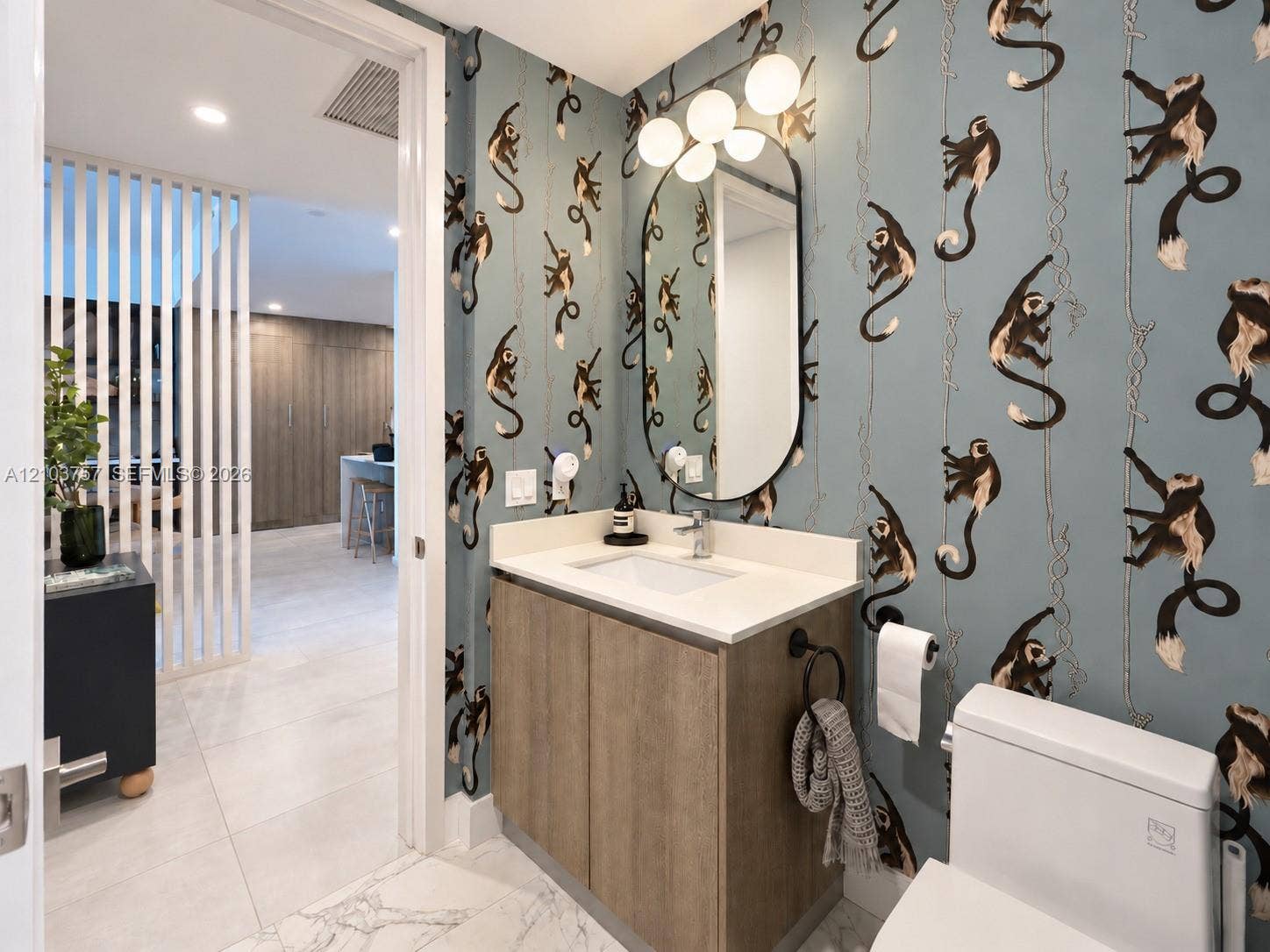 17550 Collins Avenue, #1103, Sunny Isles Beach, Sunny Isles Beach, FL 33160 Powder room featuring a single vanity with a white countertop and wood-finish cabinetry