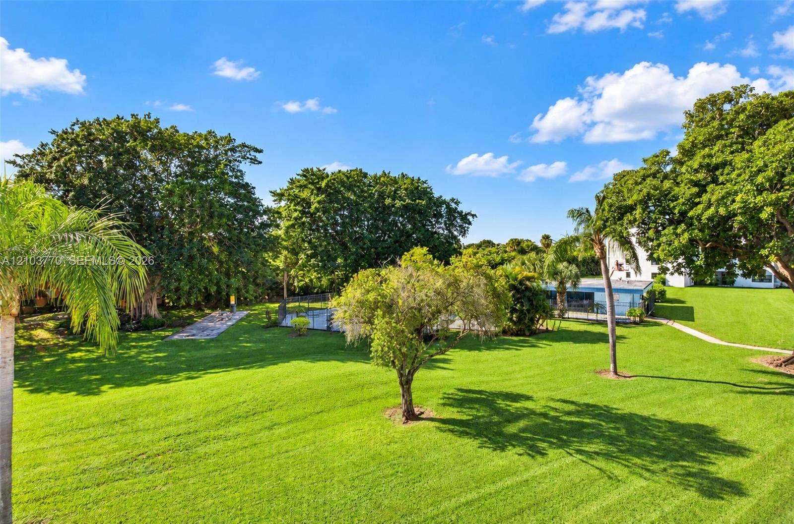 9440 SW 8th Street, #309, Boca Raton, Boca Raton, FL 33428 Expansive green lawn with mature trees and a paved walkway