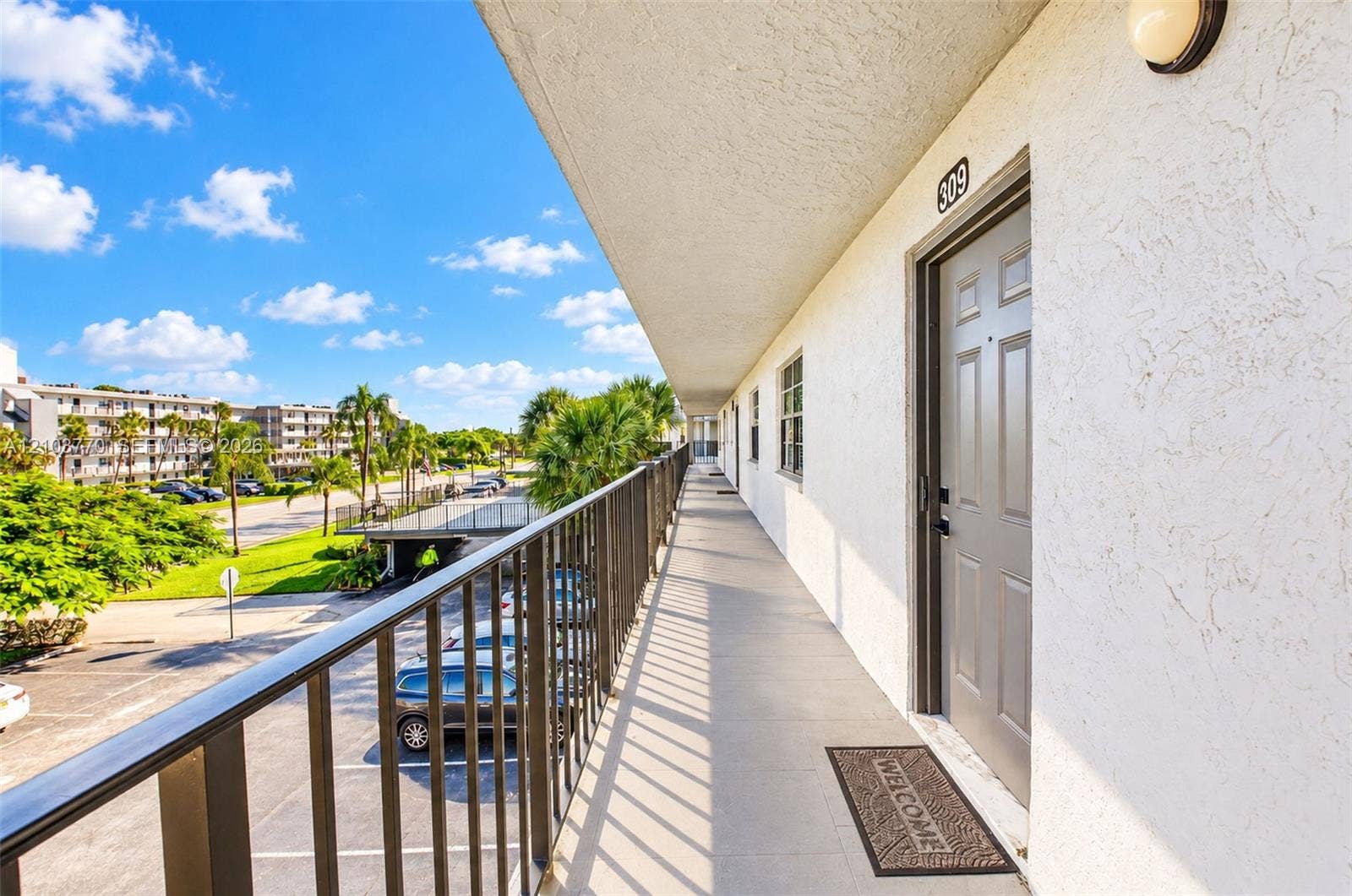 9440 SW 8th Street, #309, Boca Raton, Boca Raton, FL 33428 Upper-level walkway with a metal railing and stucco exterior