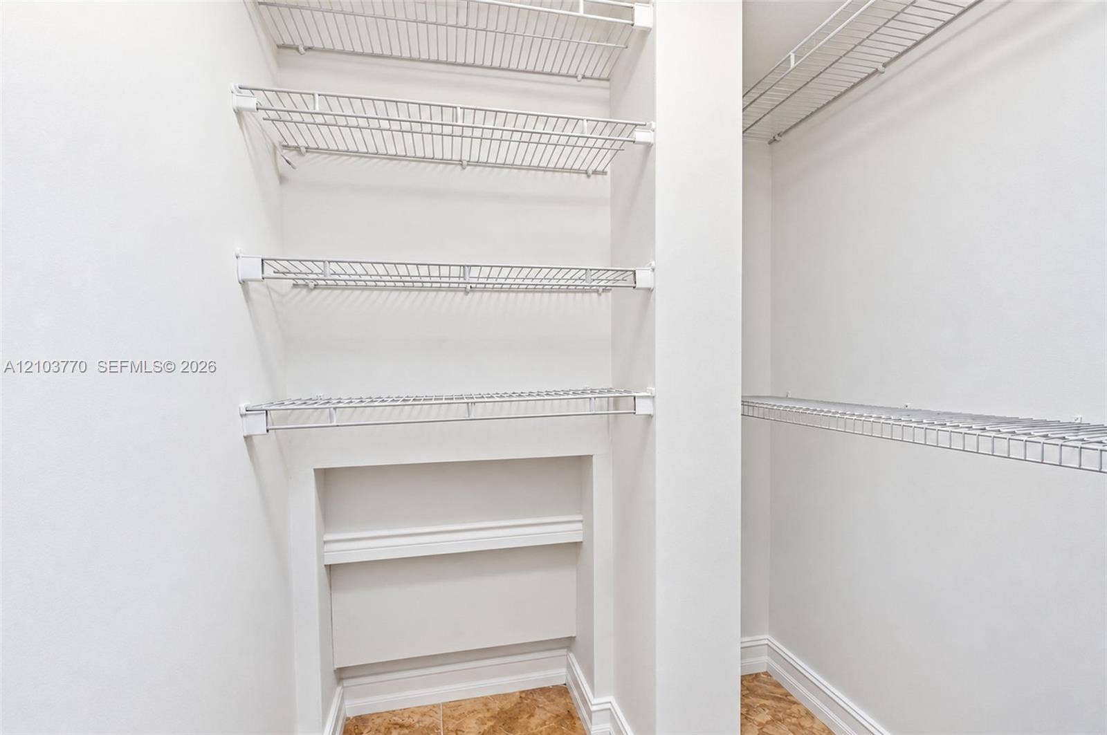 9440 SW 8th Street, #309, Boca Raton, Boca Raton, FL 33428 White wire shelving system, built-in lower shelving, white walls, and tile flooring