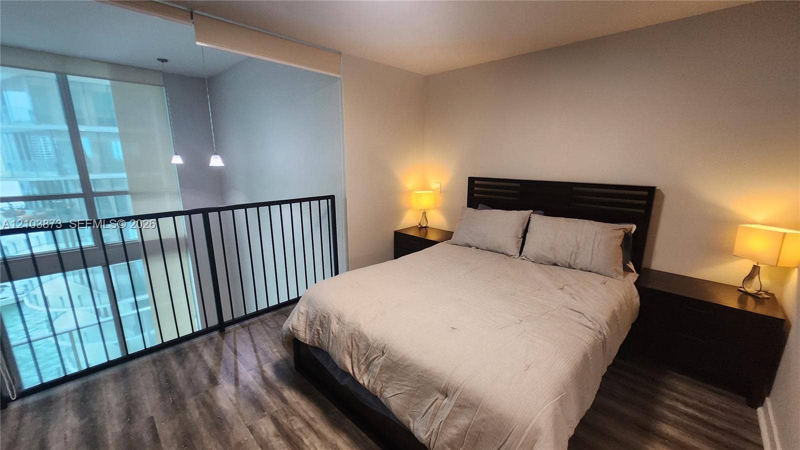 300 S Biscayne Boulevard, #L-808, Miami, FL 33131 Wood-finish flooring, floor-to-ceiling windows, and a metal safety railing