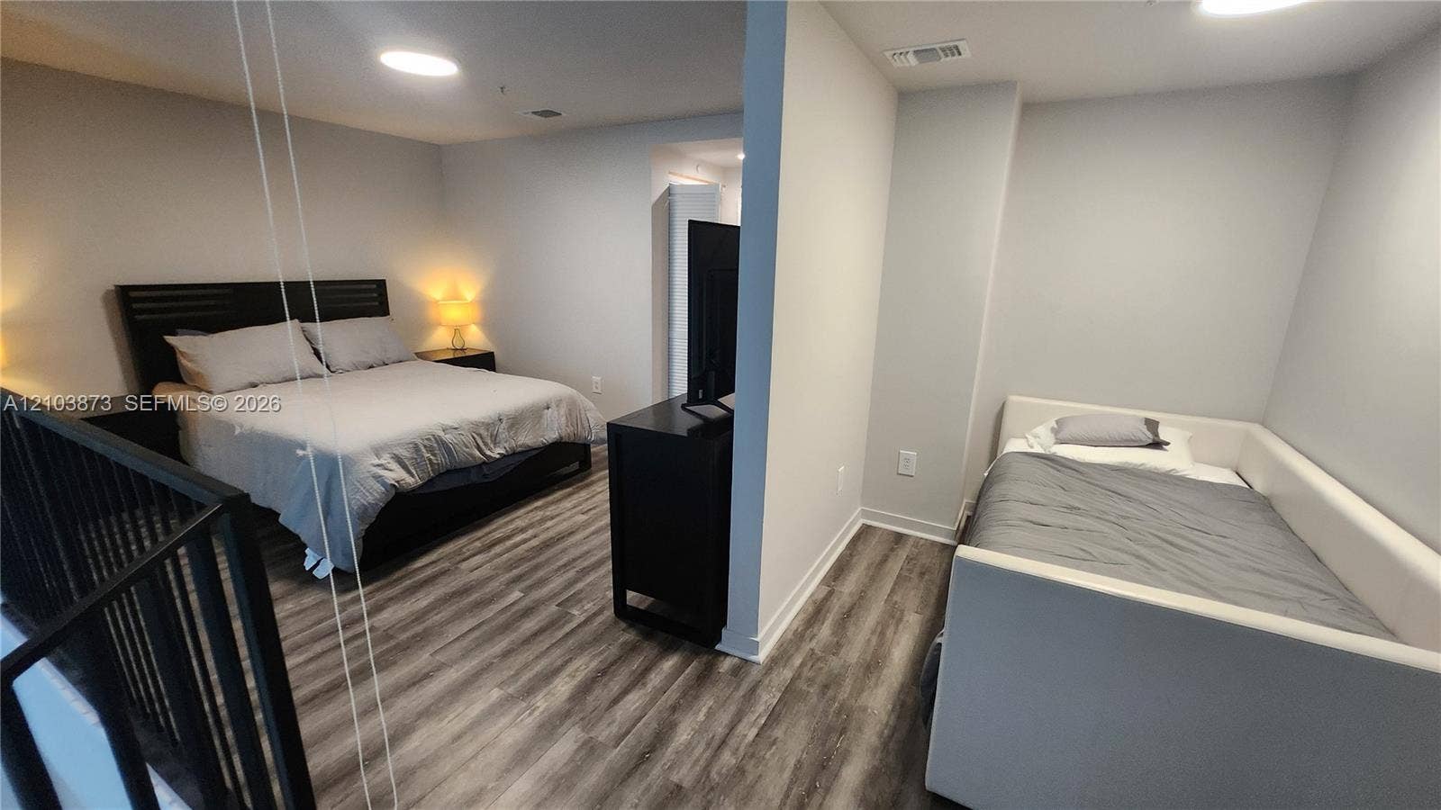 300 S Biscayne Boulevard, #L-808, Miami, FL 33131 Wood-finish flooring, recessed ceiling lighting, and a black metal railing