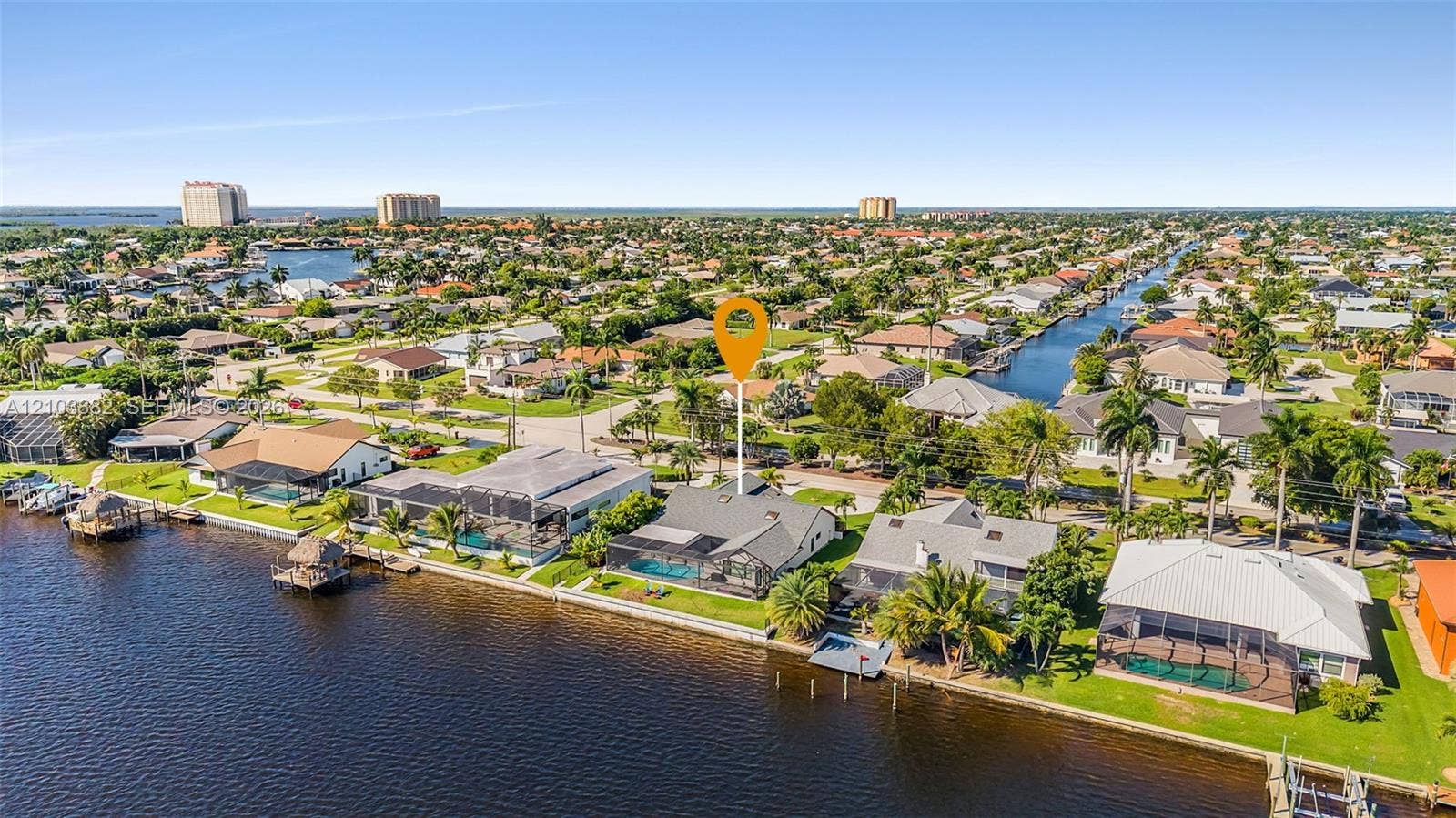 Waterfront property featuring a screened-in lanai, private pool, and direct canal access